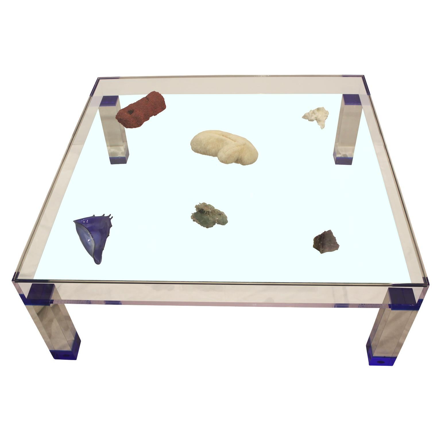 This square modern display table Lucite and glass table has a removable top for customizable displays. It is in the style of Yves Kline and Charles Hollis Jones. The leg accents are in a deep blue. Custom order can be made!