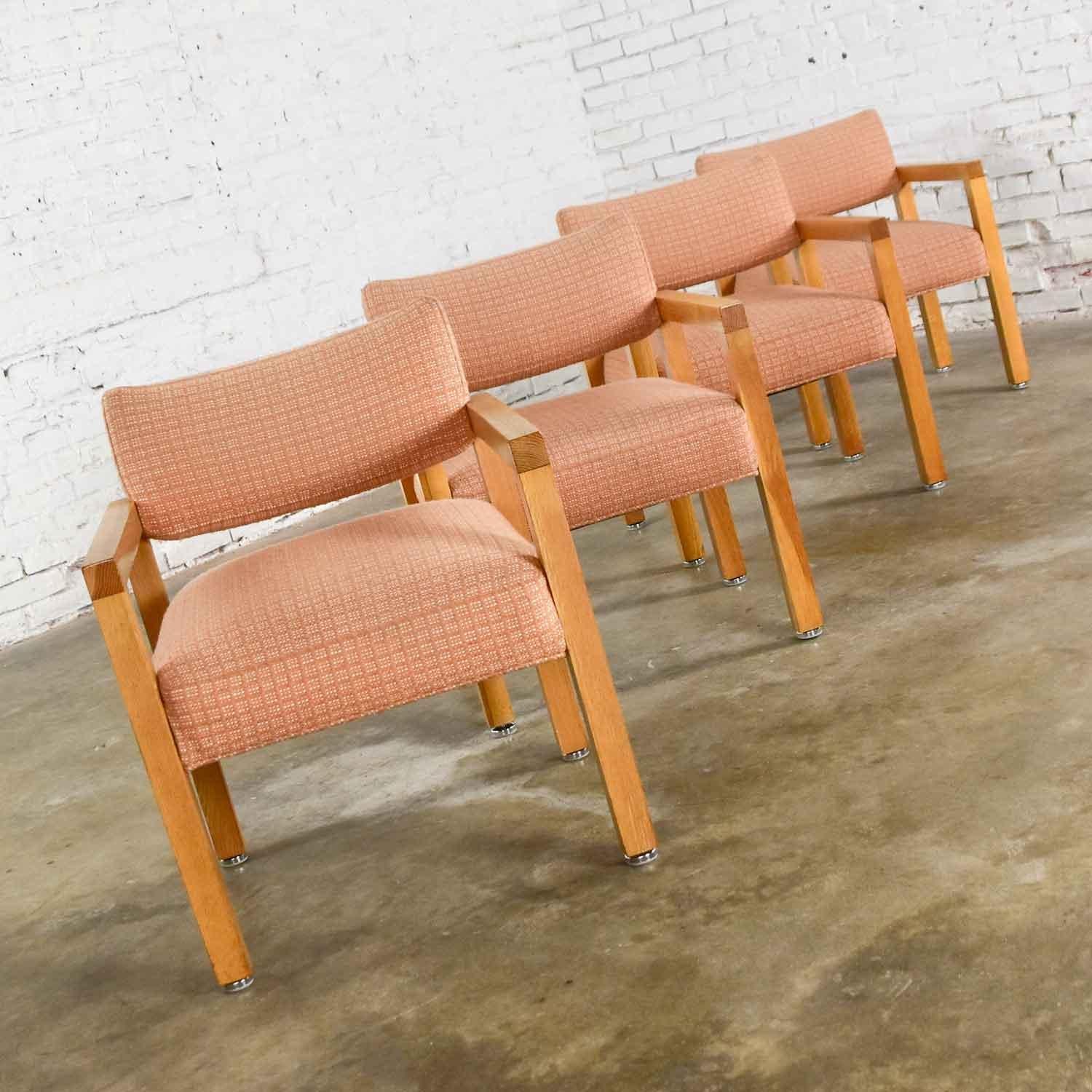 Wonderful set of four modern square frame, almost a Parsons style, armchairs comprised of oak, their original blush textured fabric, and chrome and nylon adjustable disc shaped feet. Typical age-appropriate wear, a few nicks in legs, nothing that