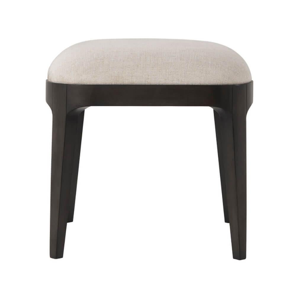 A modern stool with a dark Macadamia finish beach frame, upholstered in Swathe fabric and raised on square tapered and out flaring legs.

Dimensions: 18