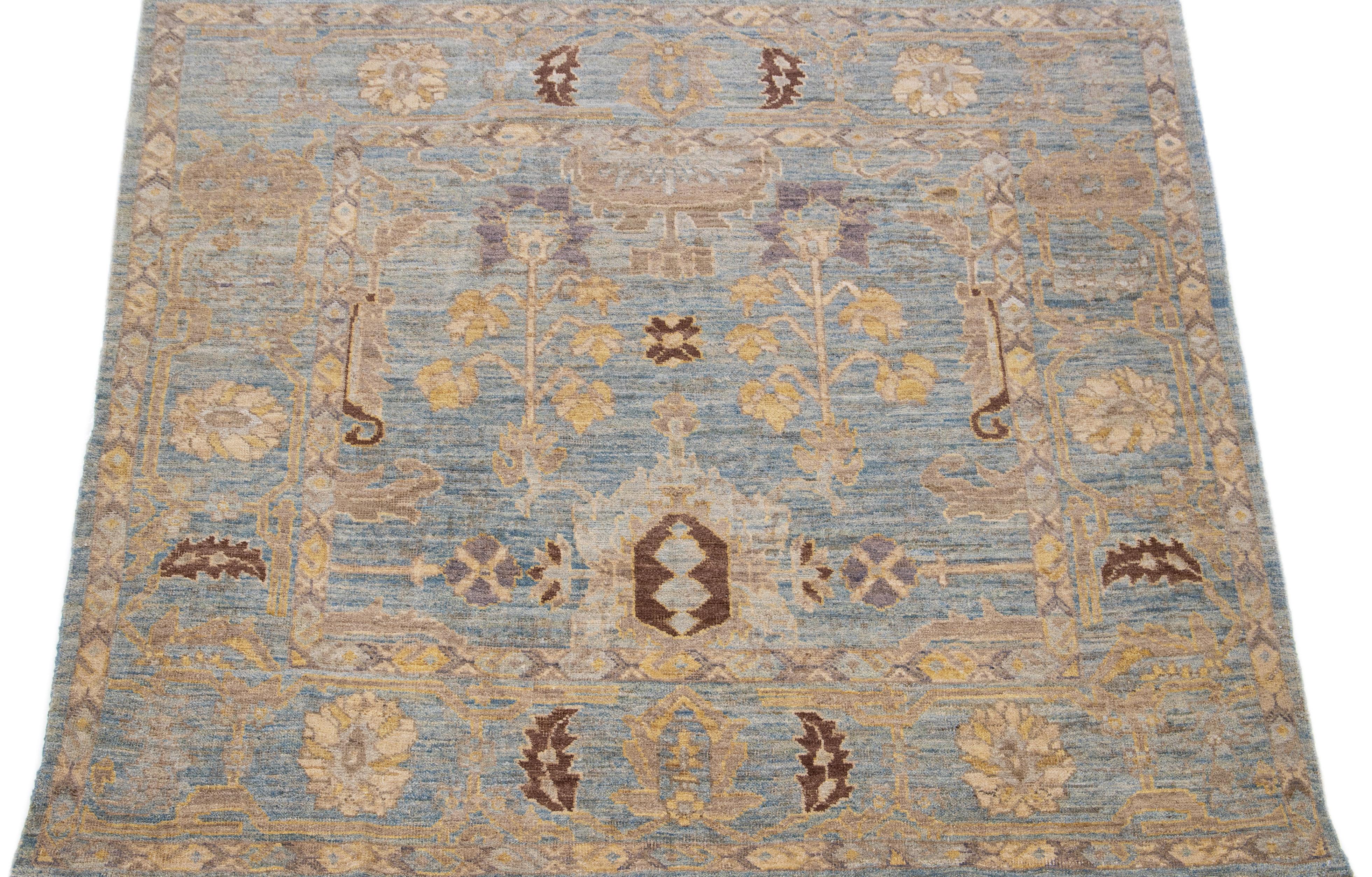 Beautiful modern Sultanabad hand-knotted wool rug with a blue color field. This rug has a designed frame with brown and yellow accents in a gorgeous all-over floral motif.

This rug measures 6' x 6'3