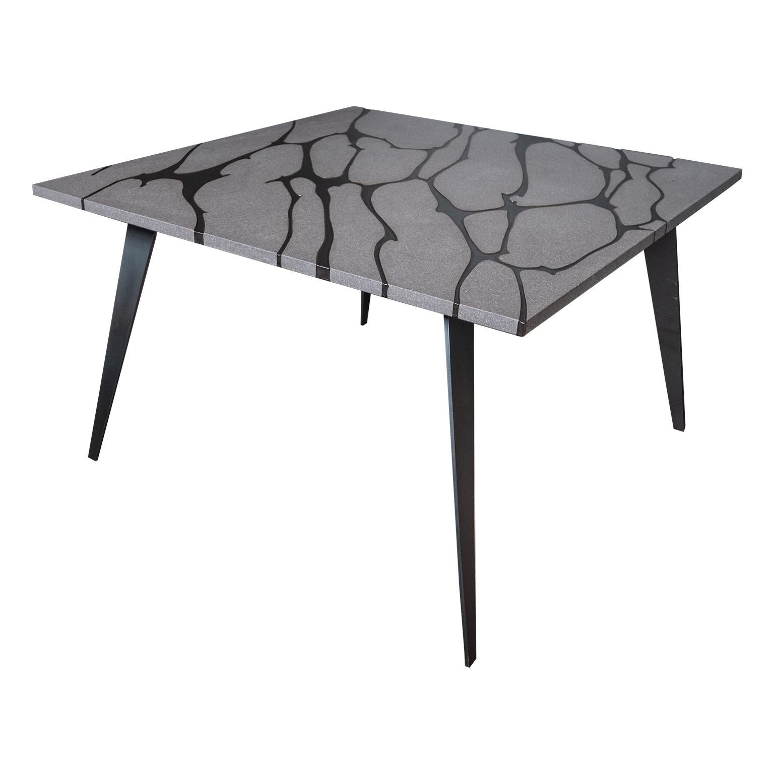 Filodifumo is a contemporary square outdoor table with top in lava stone and steel legs.
It is made with solid and compact matter.
High precision machinaries engrave on the lava stone surface 