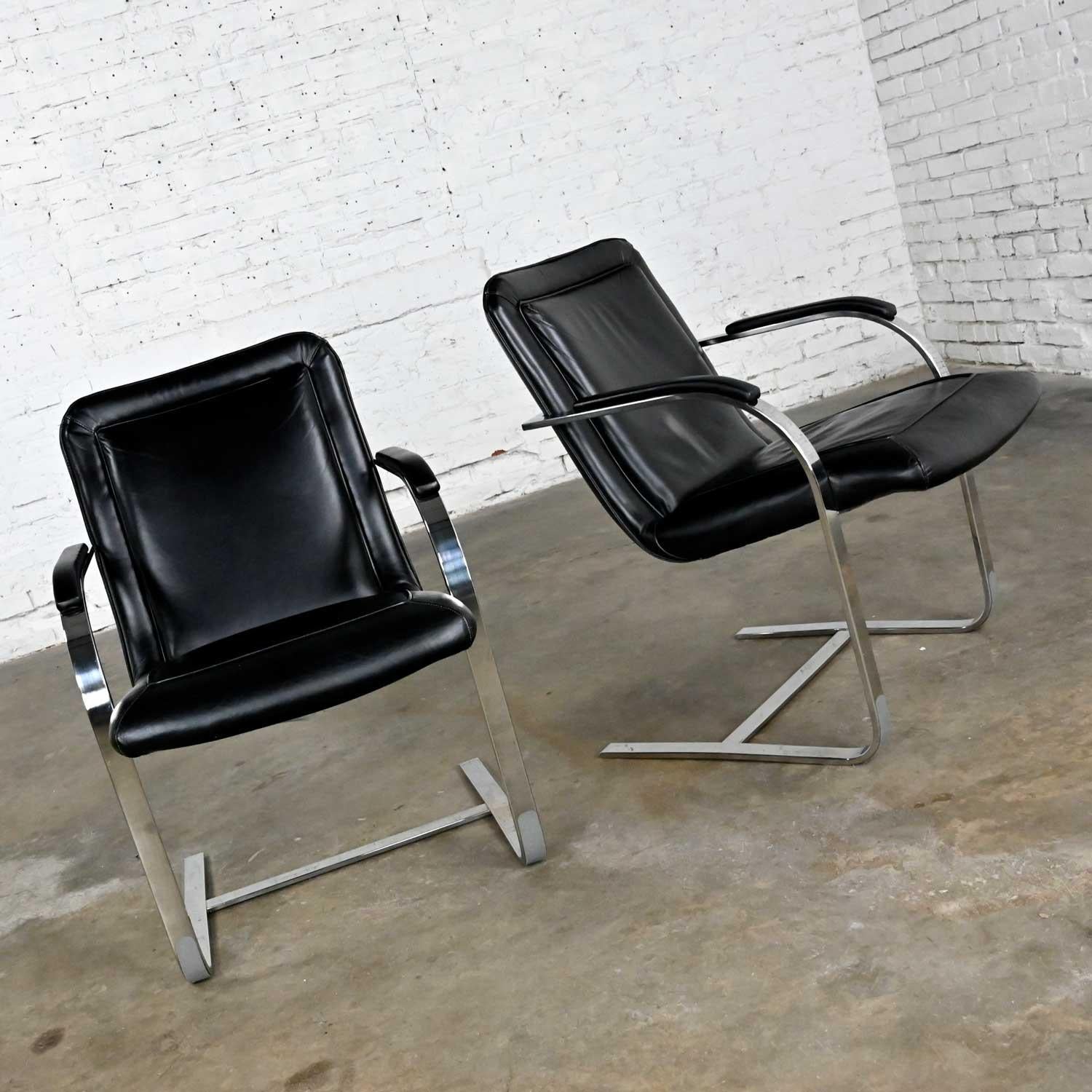 Wonderful pair of modern St. Timothy Chair Company chrome rectangular tube and black leather cantilever chairs. Beautiful condition, keeping in mind that these are vintage and not new so will have signs of use and wear. We have touched up the