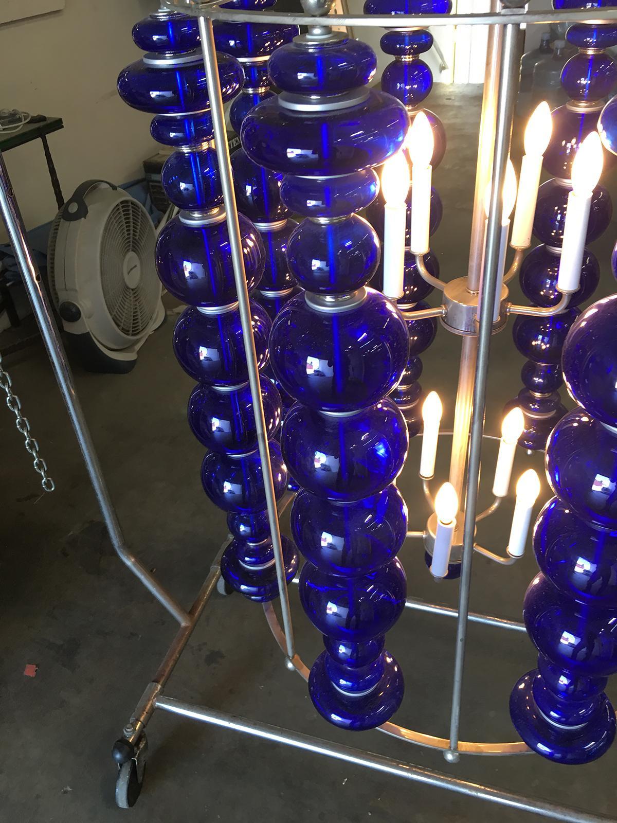 Modern stacked cobalt glass Chandelier featuring a round suspended nickel-plated frame with eight rows of custom-made stacked Cobalt glass. 