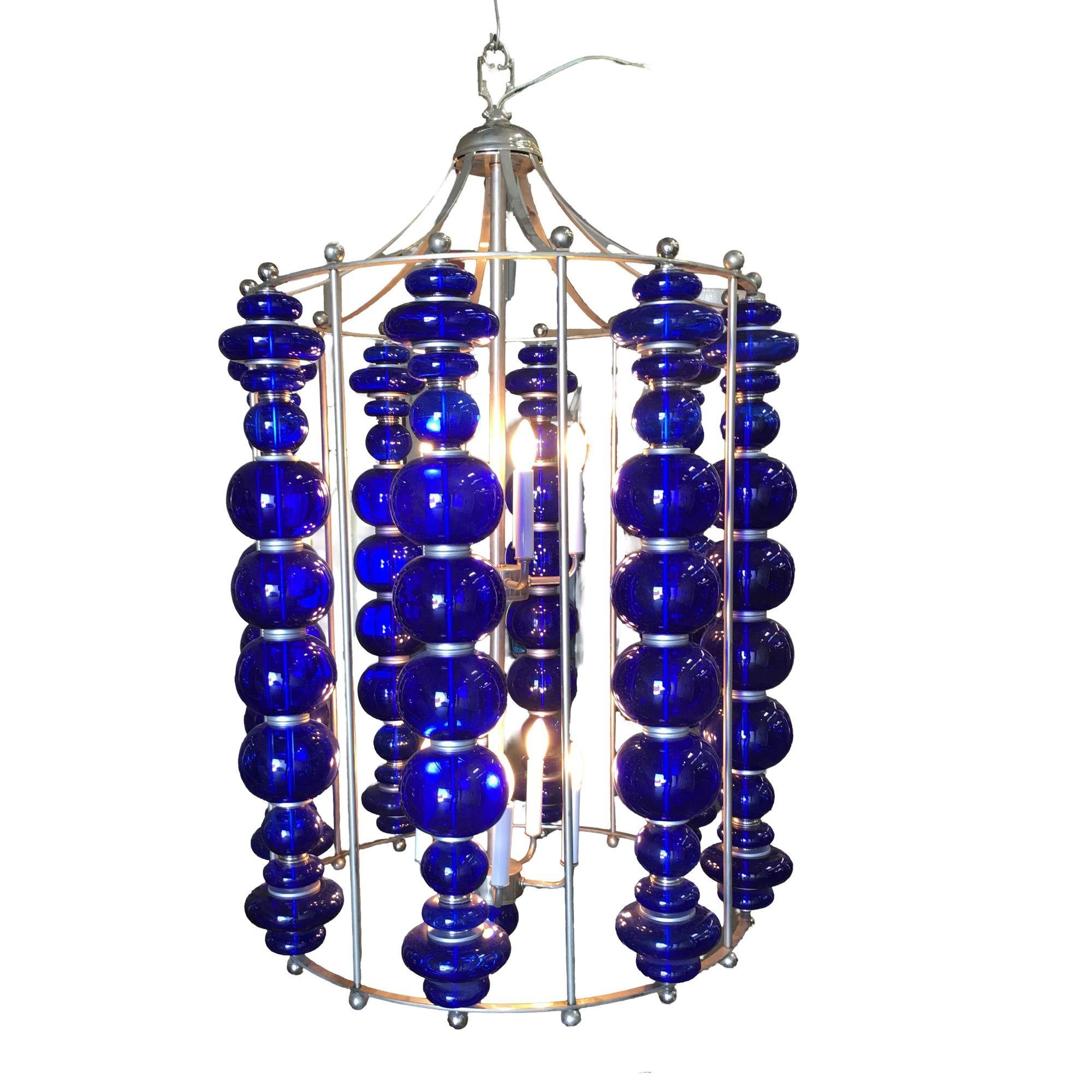 Modern stacked cobalt glass Chandelier featuring a round suspended nickel-plated frame with eight rows of custom-made stacked Cobalt glass.