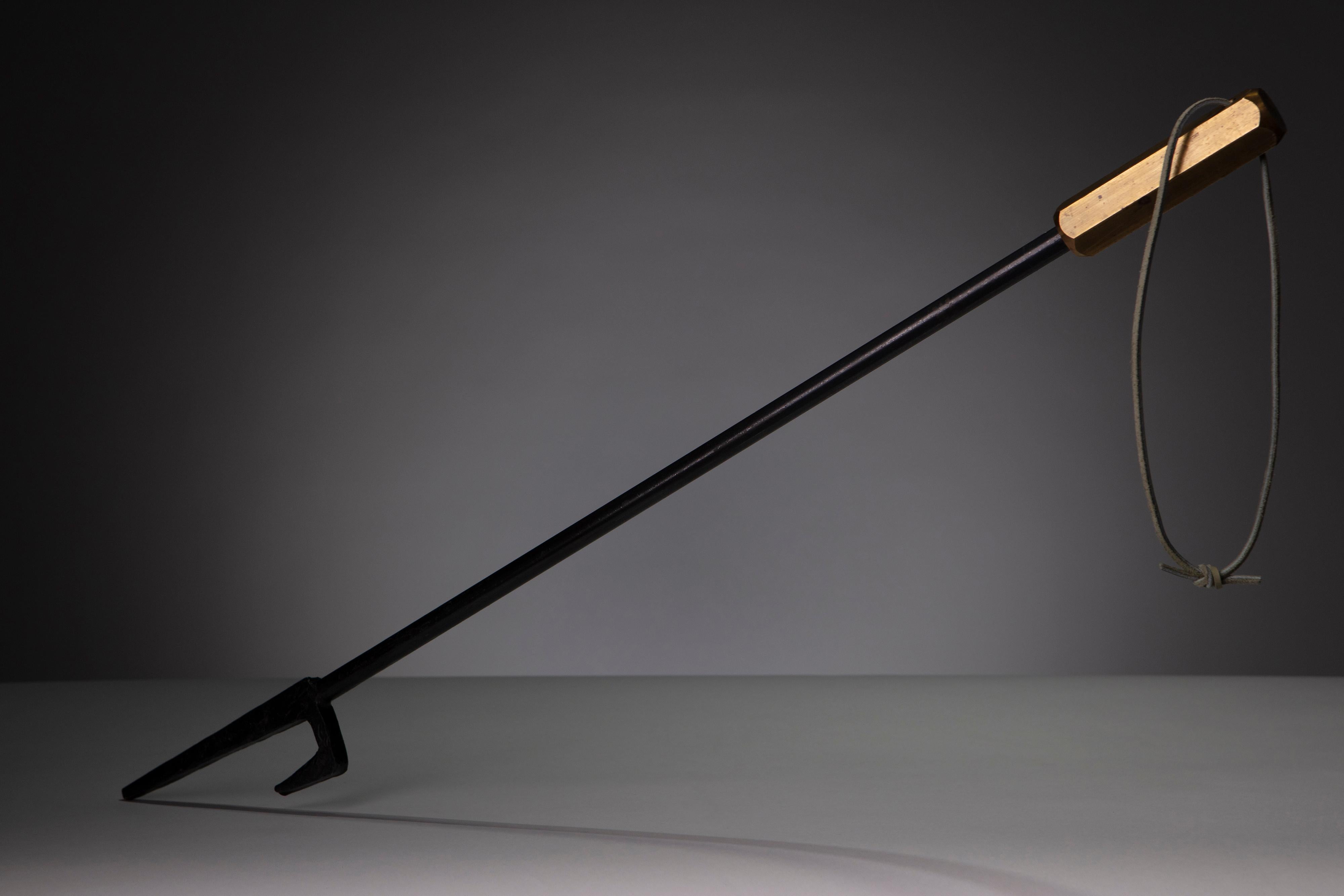 A unique contemporary steel fireplace tool with a brass forged handle. This is a one-of-a-kind piece and would make a great addition to any modern home.

Dimensions:
19 1/2