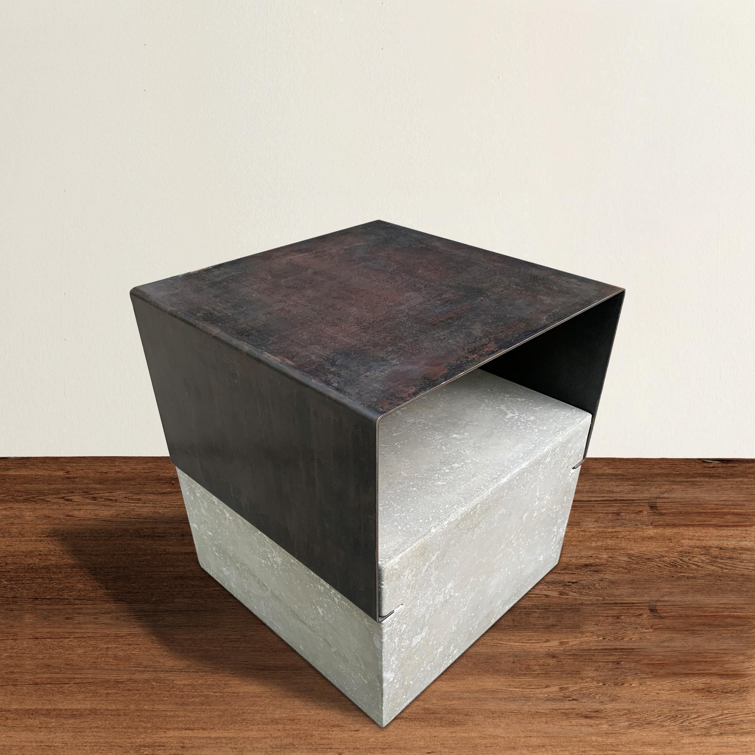 Modernists, rejoice! A chic modern-in-spirit side table constructed with a bent steel top that fits into a grooved cast concrete base.