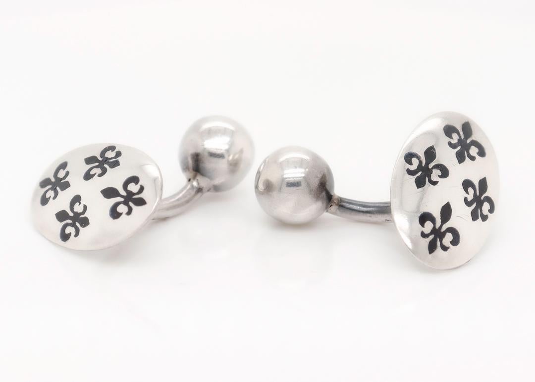 A fine pair of modern cufflinks.

In sterling silver.

With black enamel fleur-de-lys designs to each.

Simply a wonderful pair of cufflinks!

Date:
20th Century

Overall Condition:
It is in overall good, as-pictured, used estate