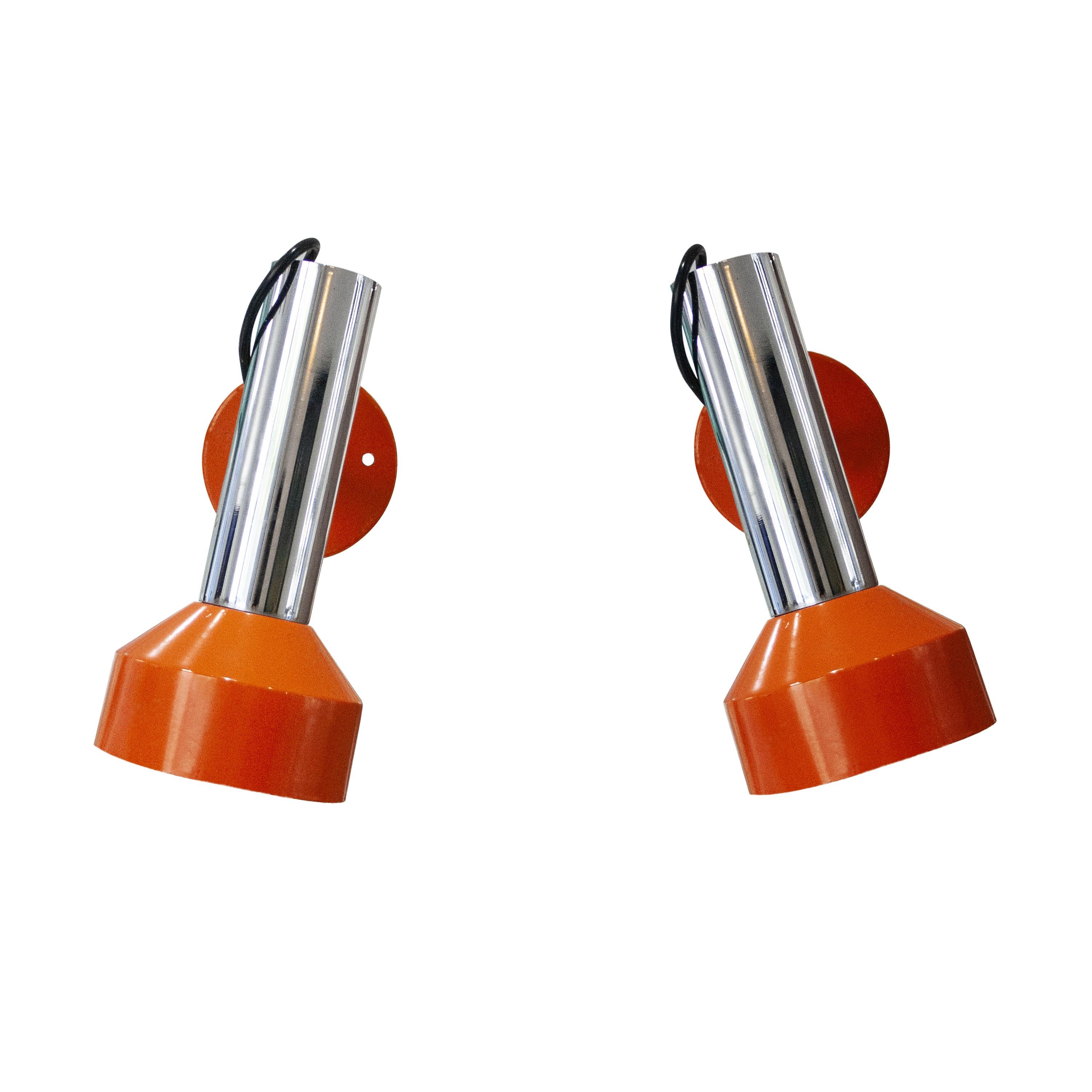  Pair of wall sconces made of chromed steel with orange lacquered details. Each one has a light point and its mobile structure allows different lighting positions and angles.
