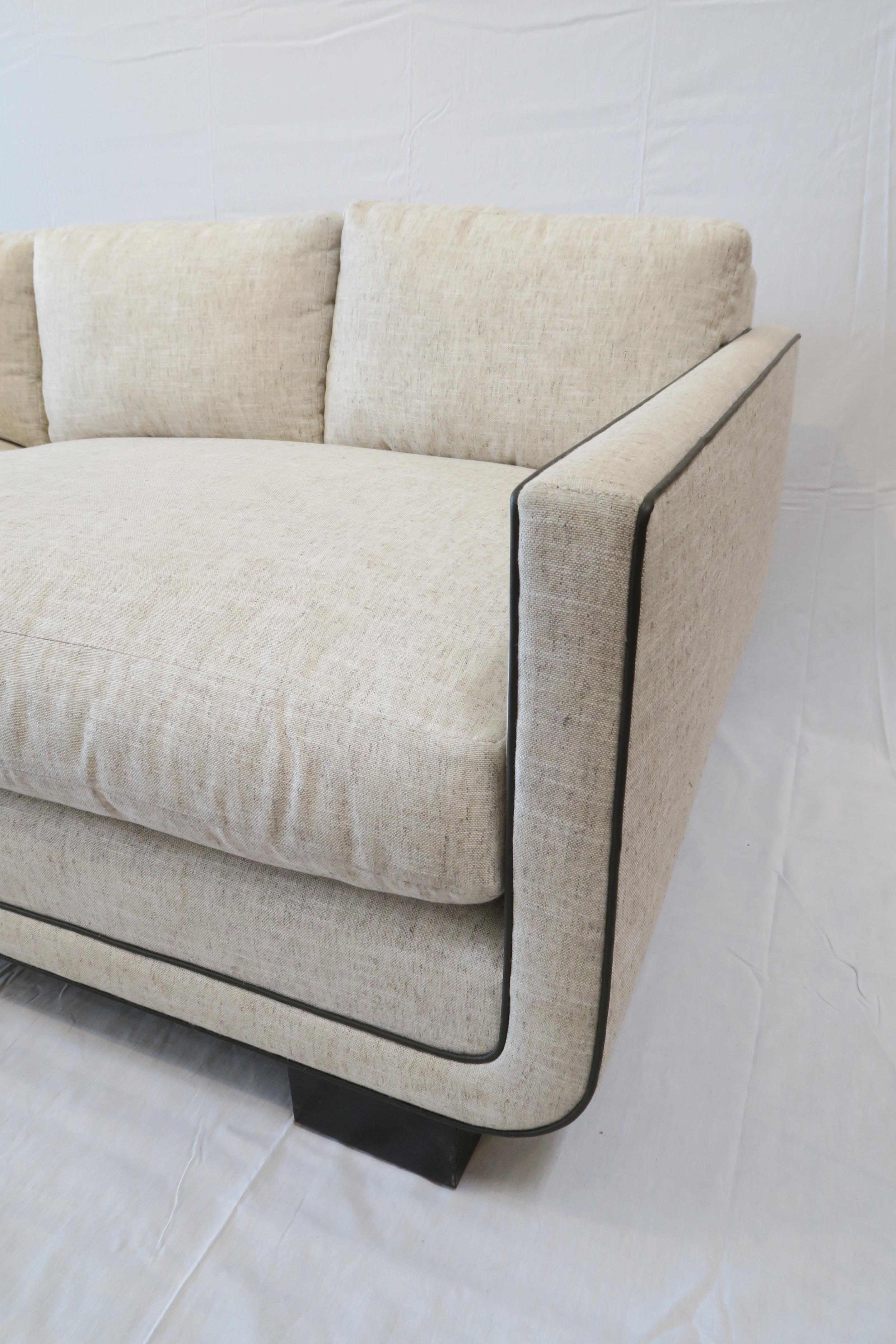 Martin & Brockett's Harrison Sofa 84” consists of a streamlined frame that curves at the base to hold a deep but tidy (4 over 2 ) mix of loose back and seat cushions. 

H 26 in. x W 84 in. x D 37.5 in.

Additional sizes and wood finishes