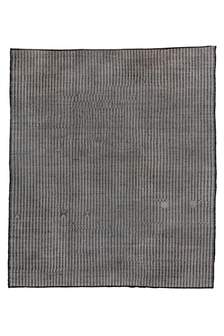 This coarsely woven, long pile carpet displays a bitonal narrow stripe pattern in beige and black running the full length of the piece. No borders, hence dimensions can be adjusted to suit. As new condition.

Rug Size
8'7x9'10