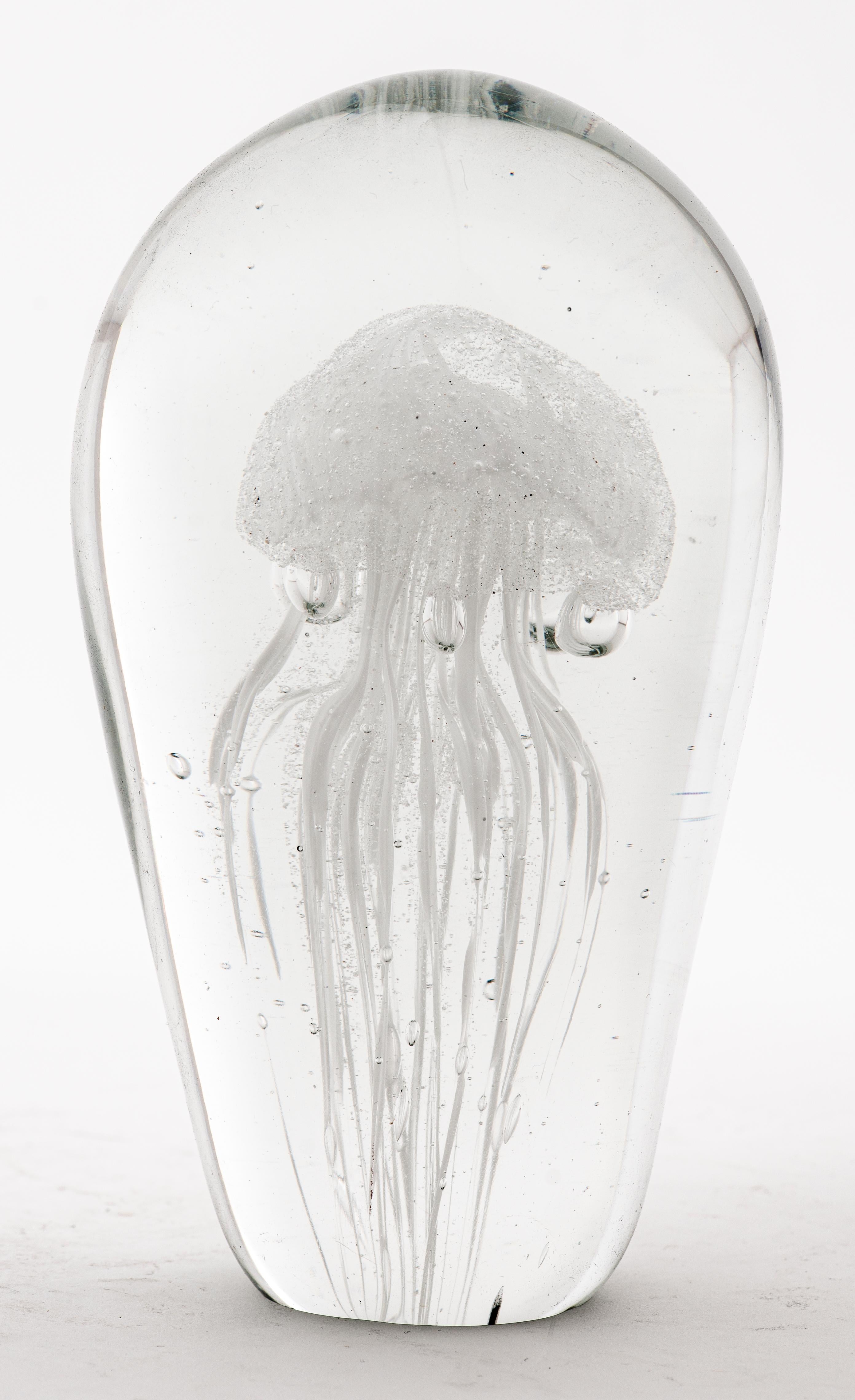 Modern studio art glass paperweight in clear glass with cased white glass and controlled bubbles forming a medusa shaped element within the piece. Unsigned. Measures: 4.25