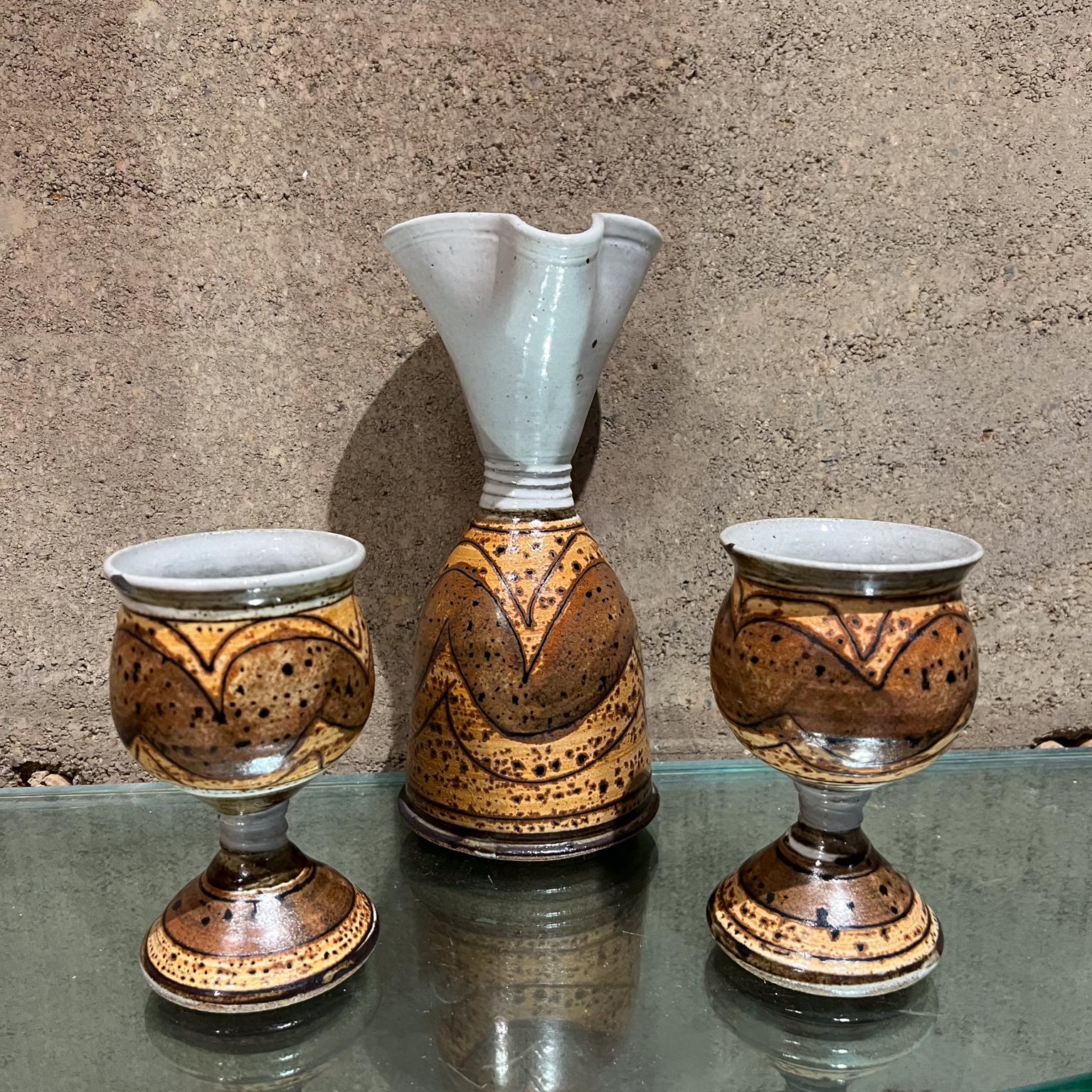 AMBIANIC presents
Studio Art Pottery Set Wine Carafe and Goblets
Stoneware Pitcher Carafe 9.5 h x 4.38 diameter Two drinking cups 5.5 x 3.18 diameter
Pitcher has a signature, unable to read.
Preowned original vintage condition
See all images.