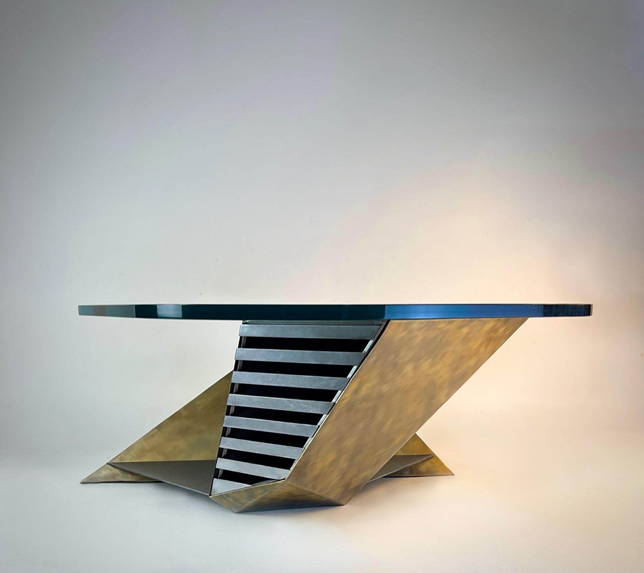 Modern studio craft glass and brass plated steel geometric coffee table. Beautiful hand cut and welded brass polished Steel. Vented areas as well as triangular design in table. The steel base is clear coated. Glass top has rounded polished corners