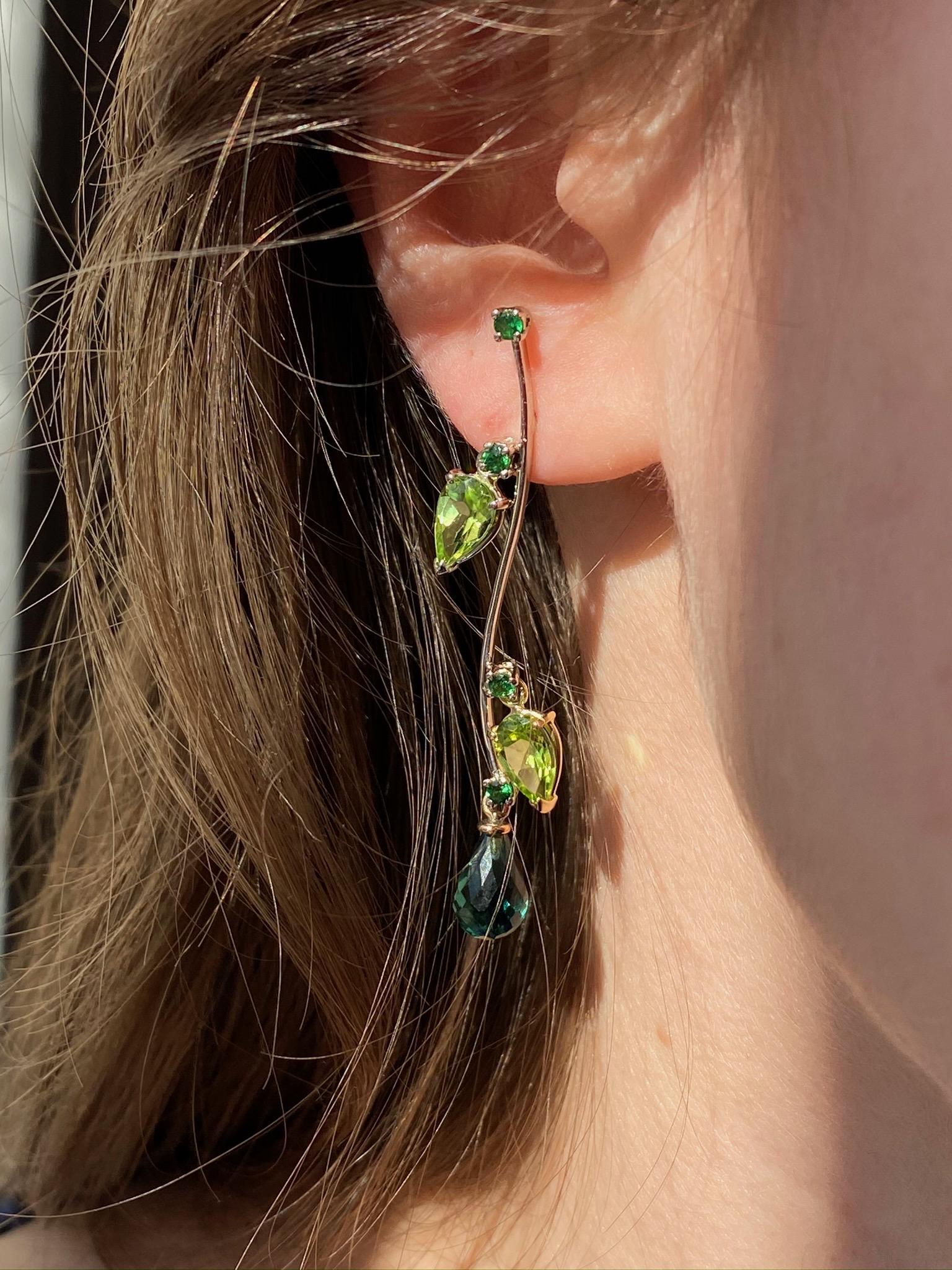 Rossella Ugolini Design Collection a Classy dangle earrings handcrafted in 18 Karats Gold with three shade of green colors:  Peridot pear cut,  Tsavorite round cut , green Tourmaline Briolet drops.  The branches of the trees of Villa Borghese in
