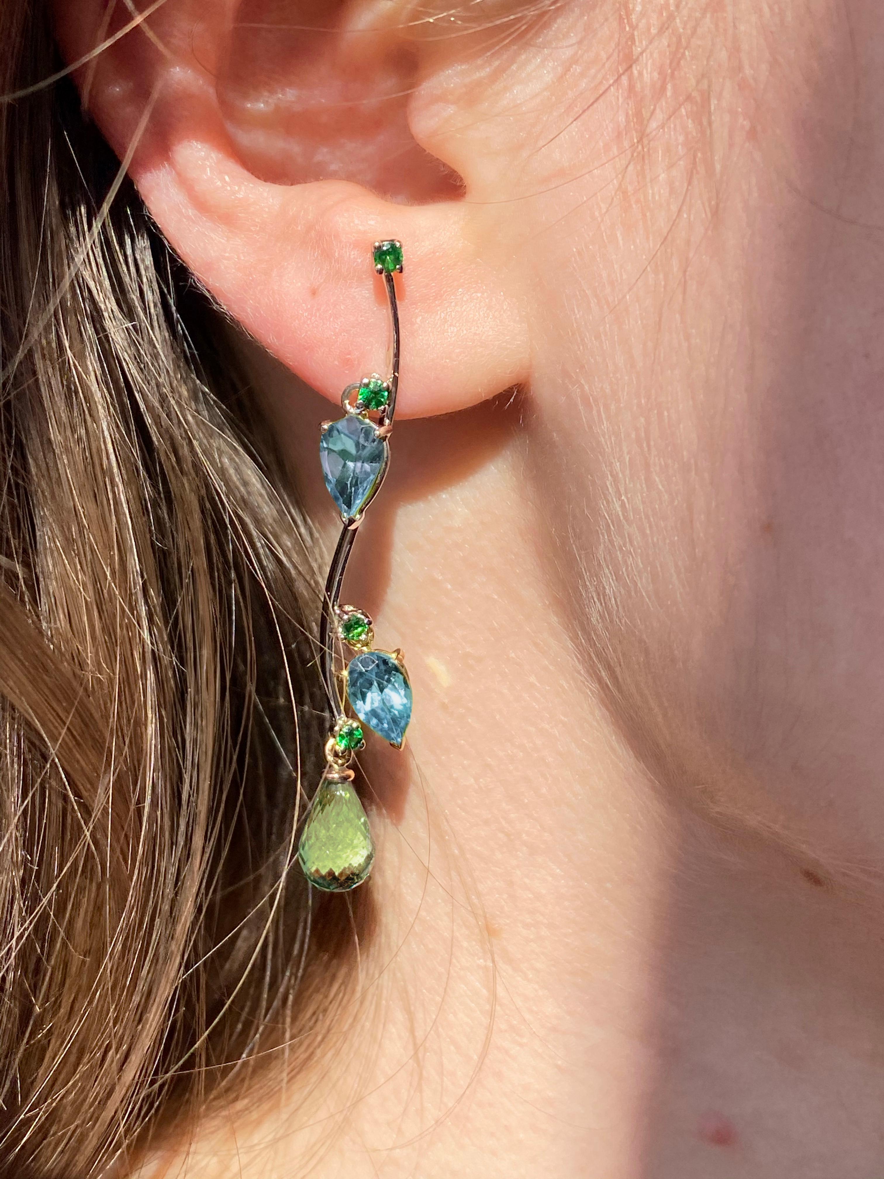 Rossella Ugolini Design Collection a Modern Style dangle Earrings Handcrafted in 18 Karats Gold with shade of blue and green colors:  Blue Topaz pear cut,  Tsavorite round cut , light green Tourmaline briolet drops.  The branches of the trees of