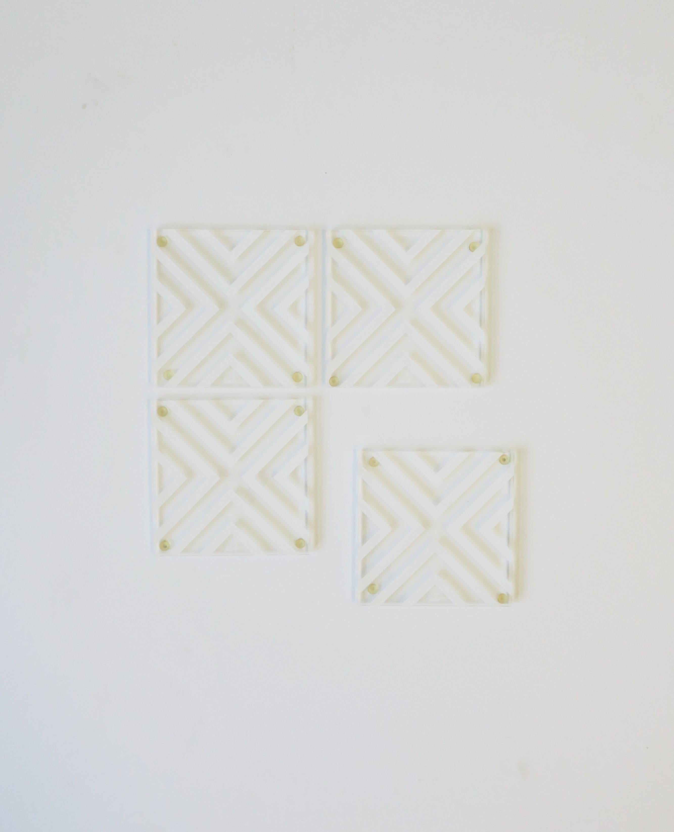 A chic set of four (4) Modern style acrylic cocktail coasters with Chevron pattern design. Coasters are clear and white acrylic. Coasters are essential for protecting furniture surfaces. Very good condition as shown in images. Dimensions: 3.75