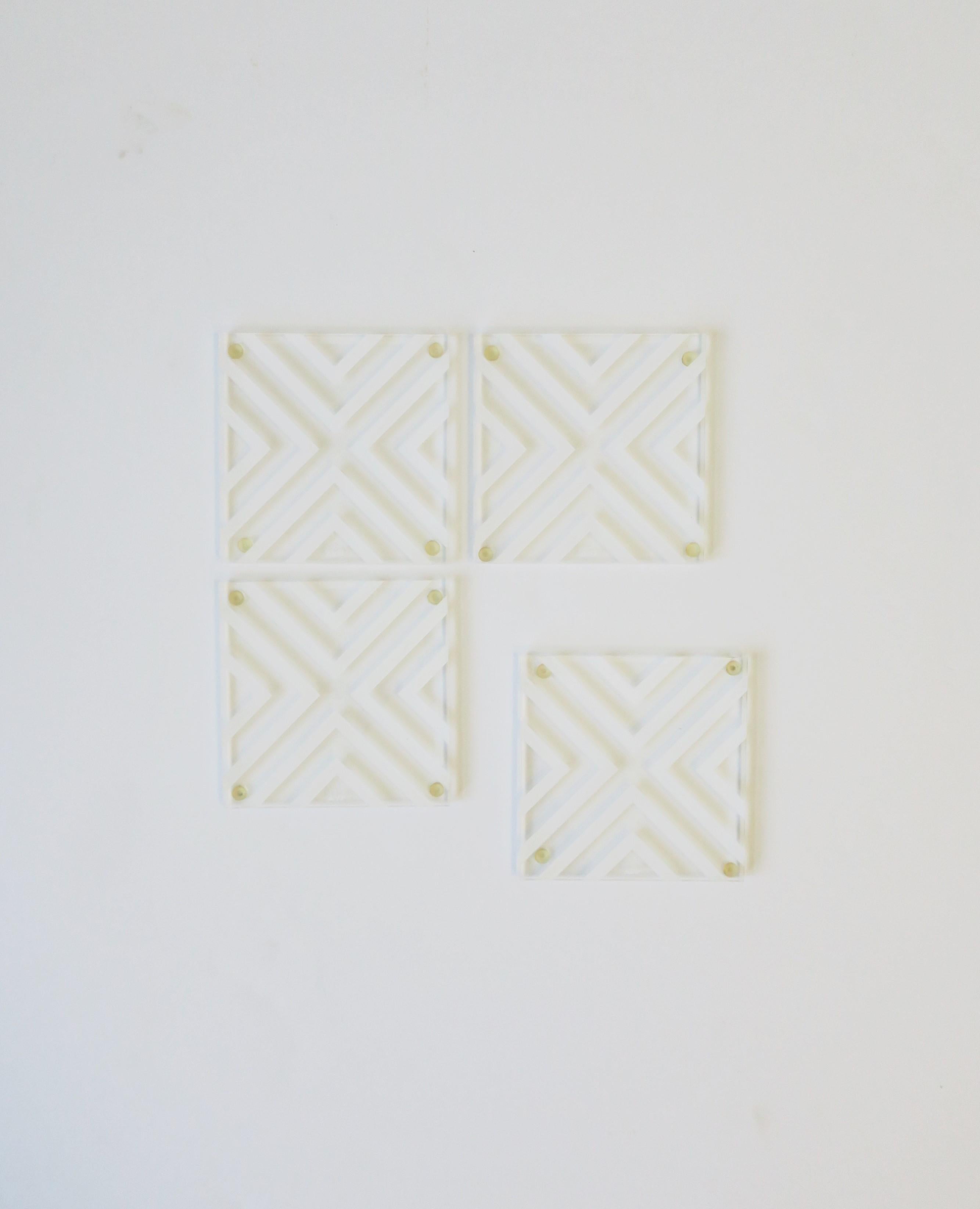 A chic set of four (4) Modern style acrylic cocktail coasters with Chevron pattern design by Alexandra von Furstenberg. Coasters are clear and white acrylic. Coasters are essential for protecting furniture surfaces. Dimensions: 3.75