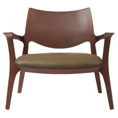 Modern Style Aurora armchair Sculpted in solid walnut finish, leather seating 