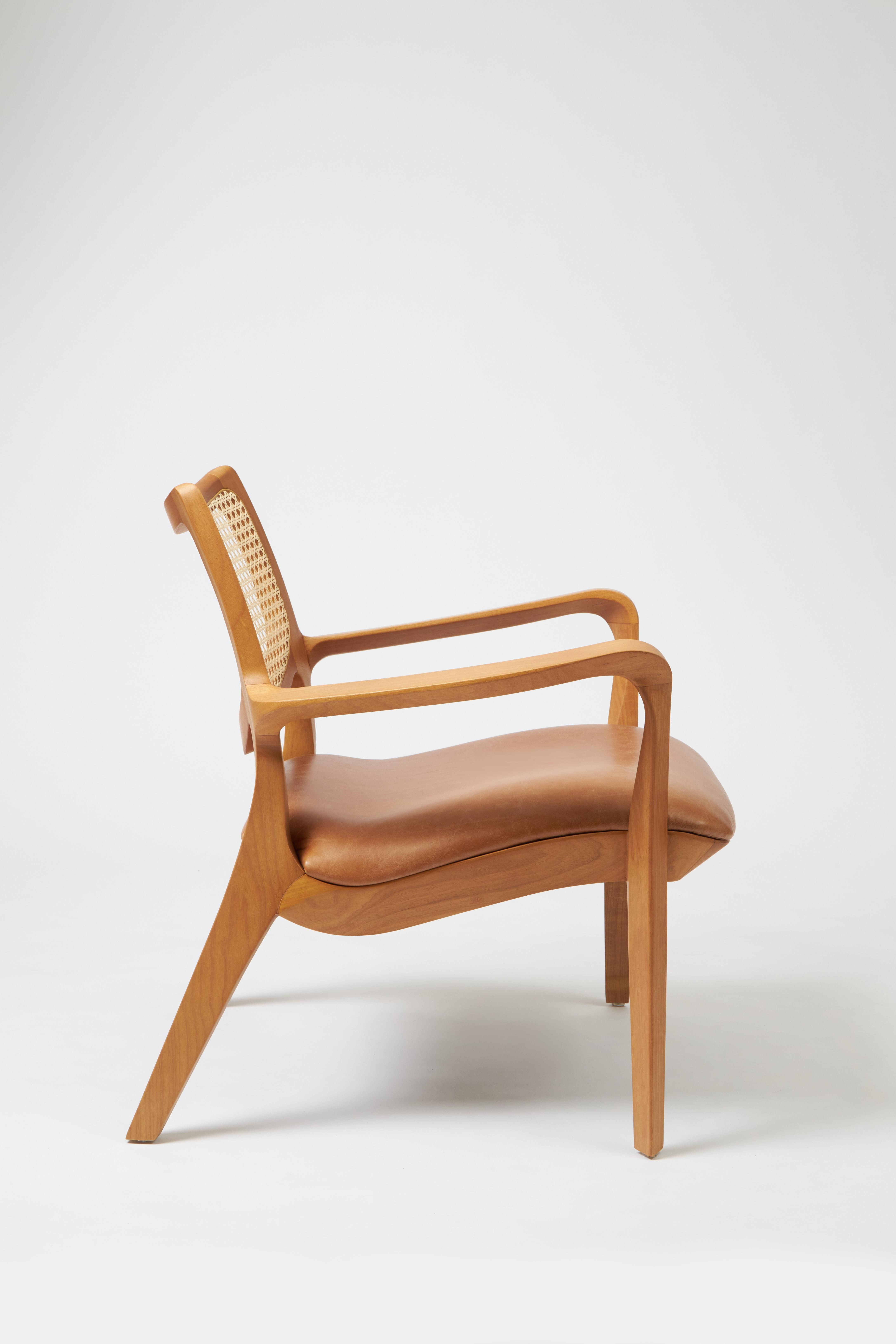 Post-Modern Modern Style Aurora armchair Sculpted in solid wood, caning back, leather seat For Sale