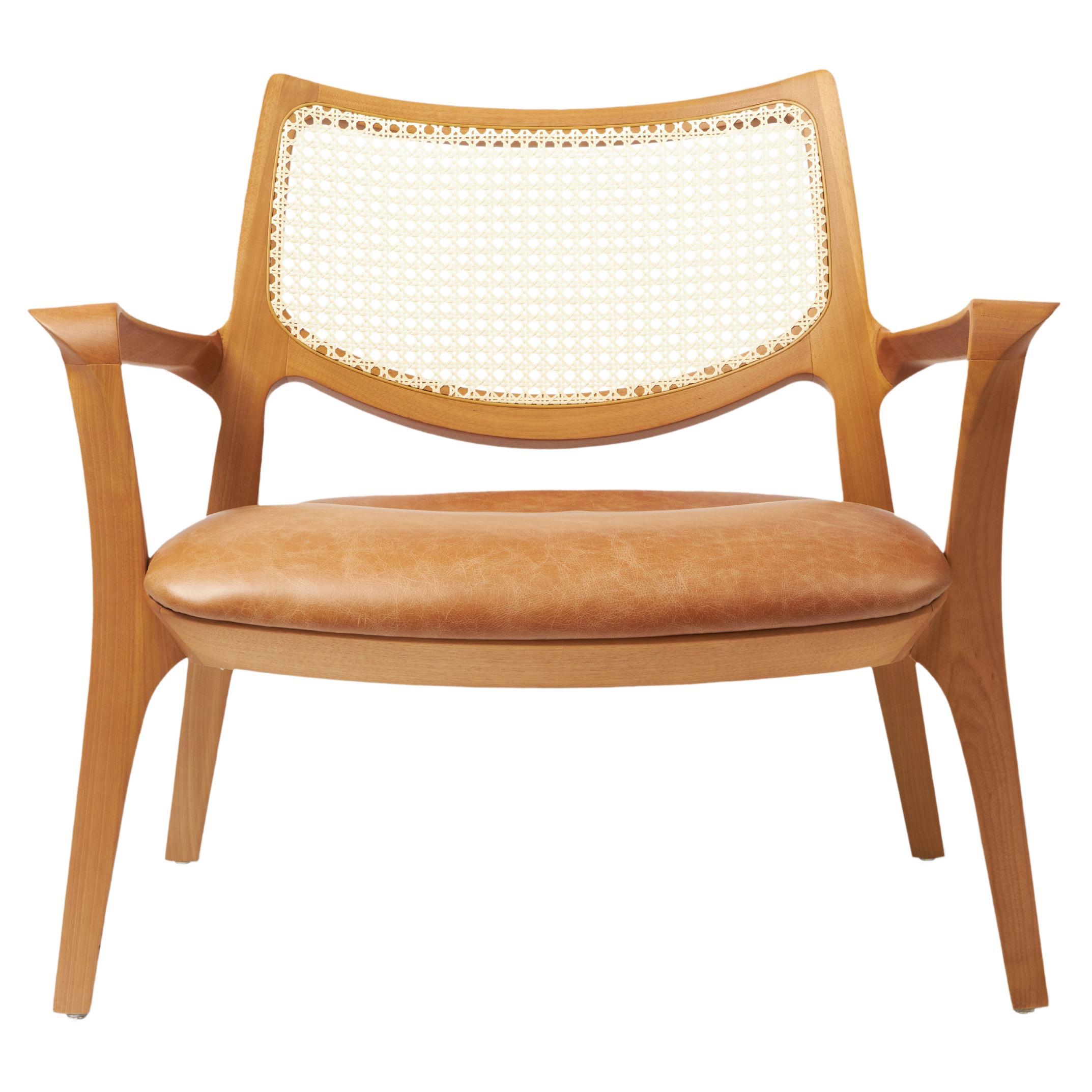 Modern Style Aurora armchair Sculpted in solid wood, caning back, leather seat