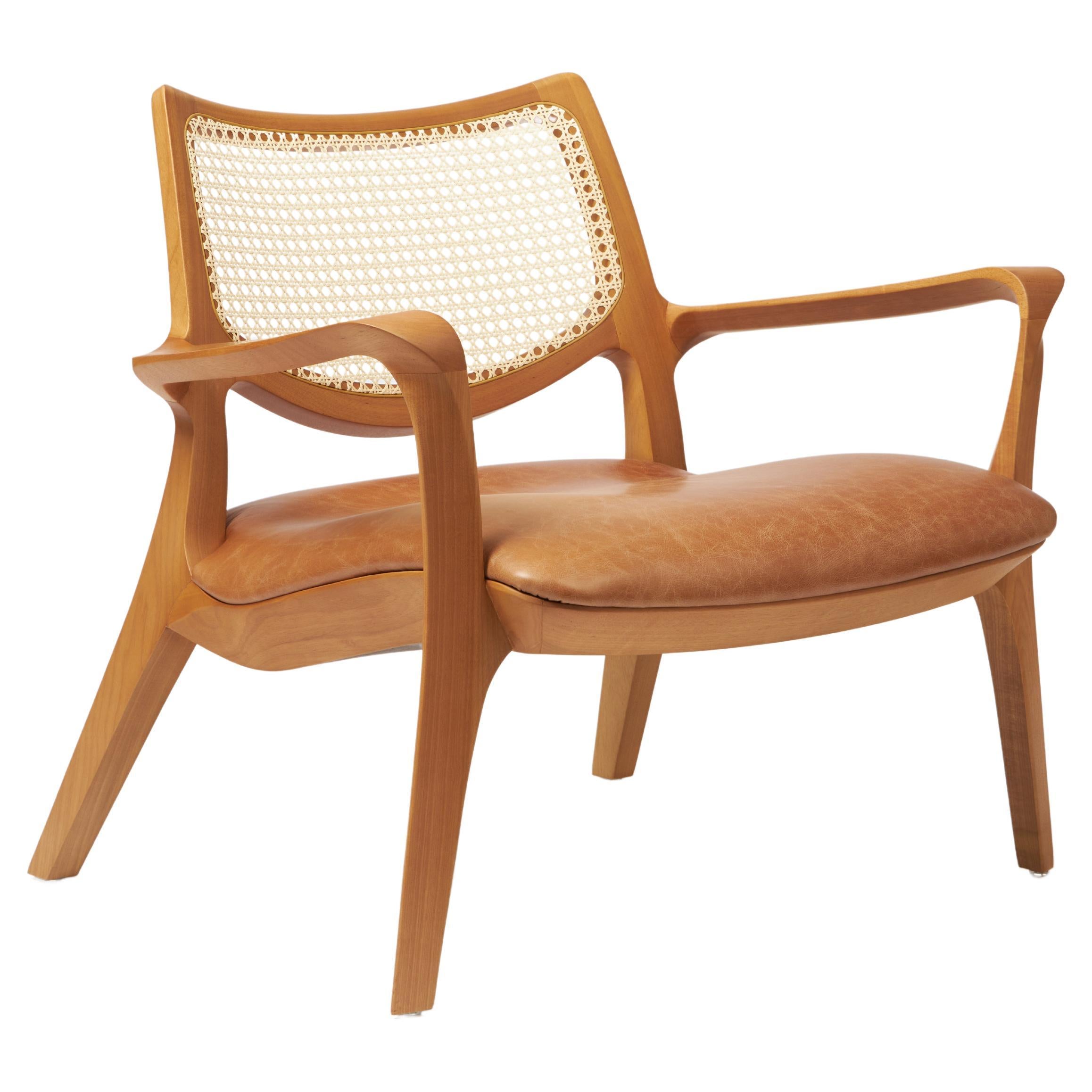 Modern Style Aurora armchair Sculpted in solid wood, caning back, leather seat For Sale