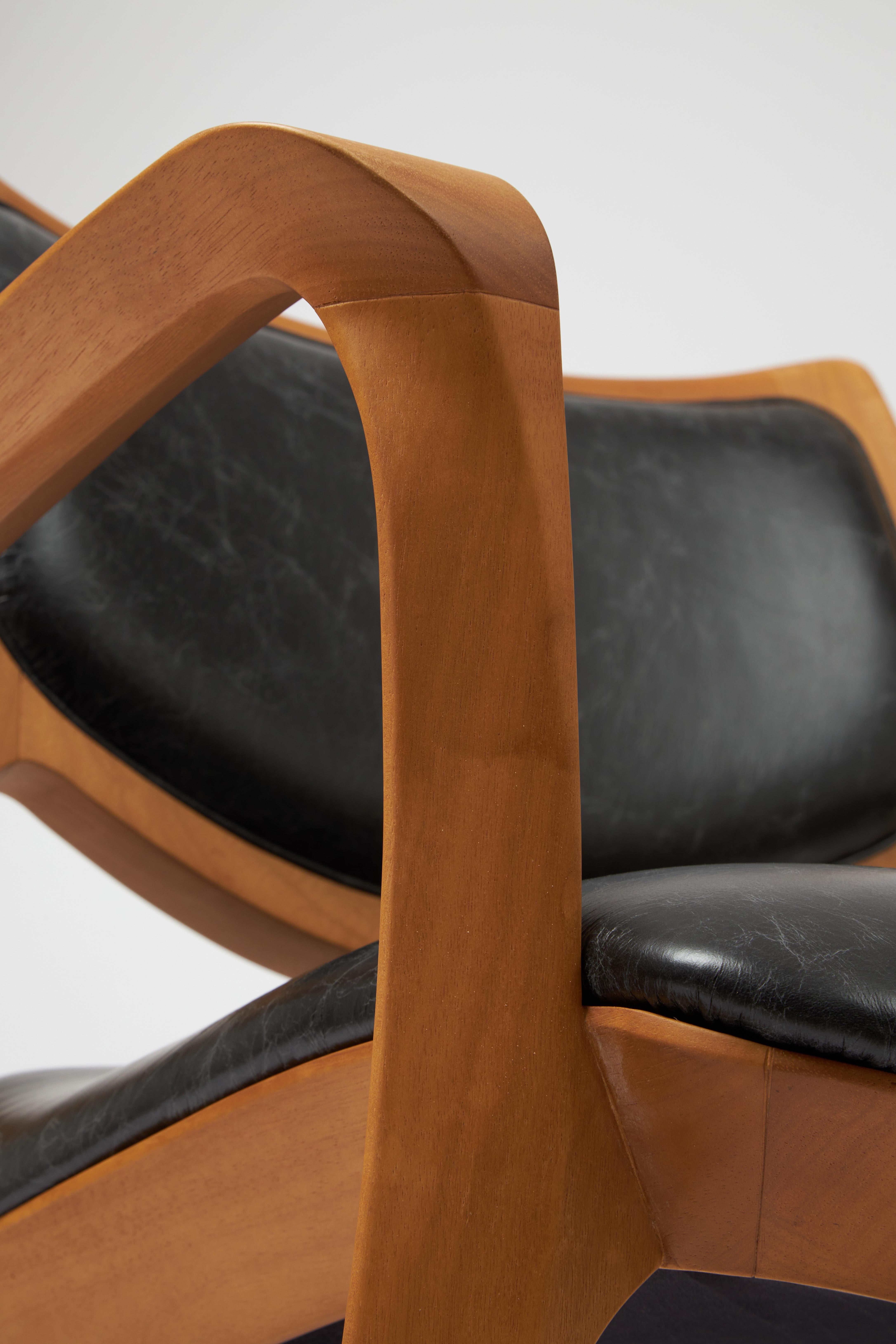 Leather Modern Style Aurora armchair Sculpted in solid wood, leather seat and back For Sale