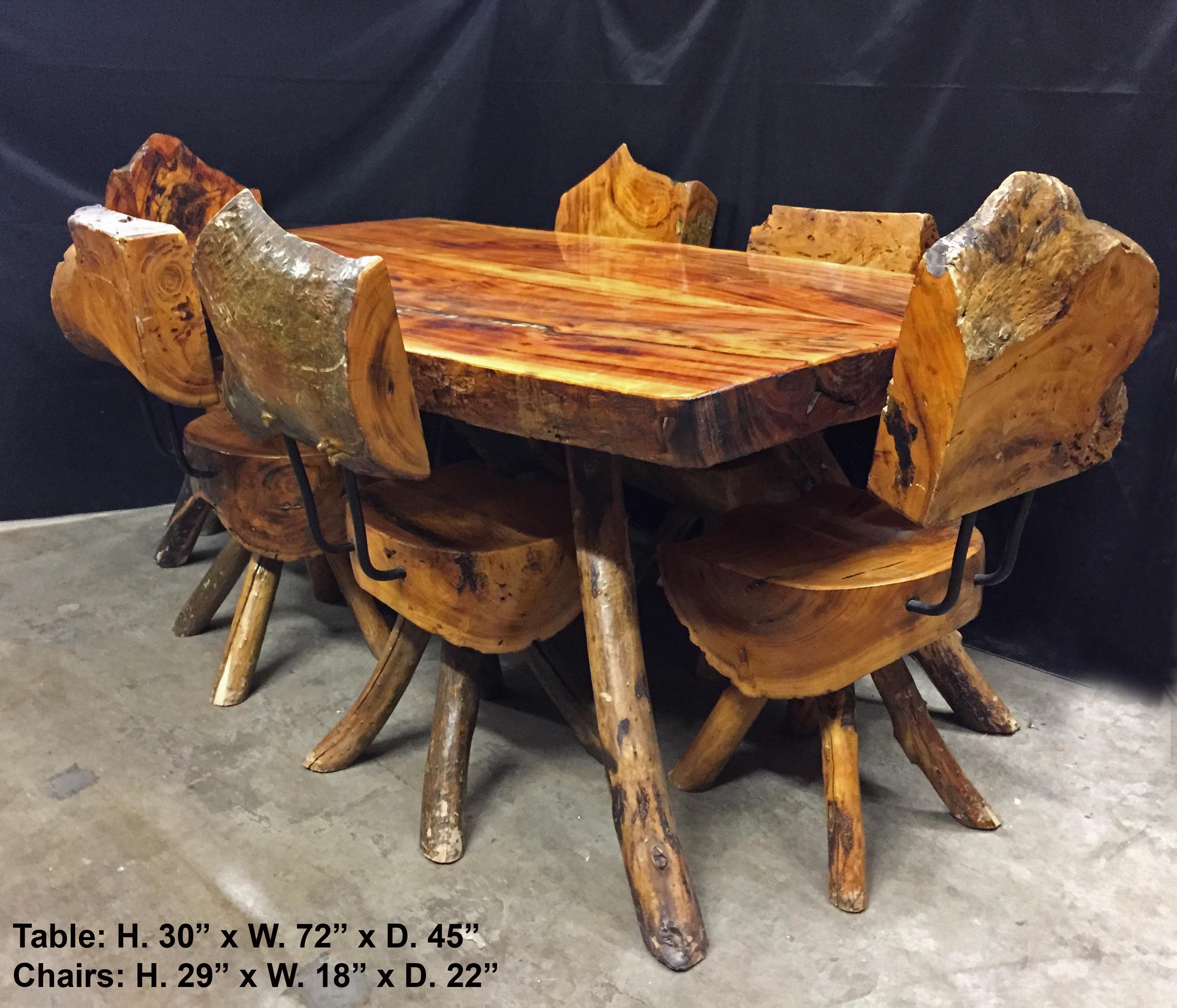 Lovely modern style carved exotic wood seven piece dining set with mother of pearl inlay.
Each piece is cut from an exotic tree trunk and later inlaid with mother of pearl. The tabletop is cut from a very large singular piece of exotic wood. The