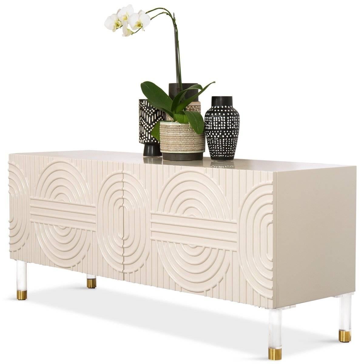 Introducing the Florence 2 Door Petite Credenza, featuring doors defined by bold concentric circles, ovals, and parallel lines. This credenza is both fresh and timeless in its design. Round lucite and brass legs complete the look. Its smaller size