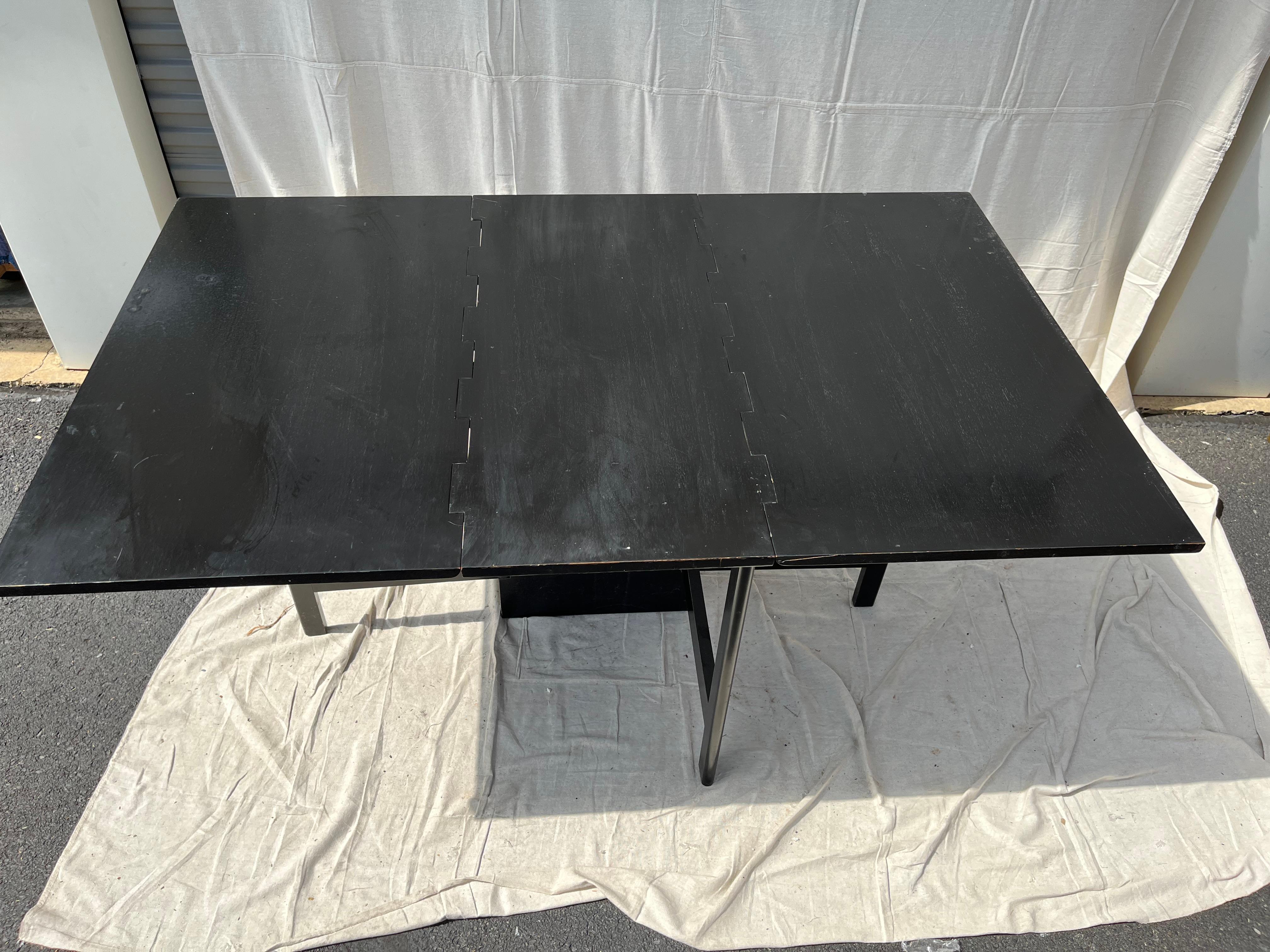 A modern gateleg drop-leaf dining table in black ebonized finish, nicely made. Measure: 18.5 inches deep when leaves dropped.