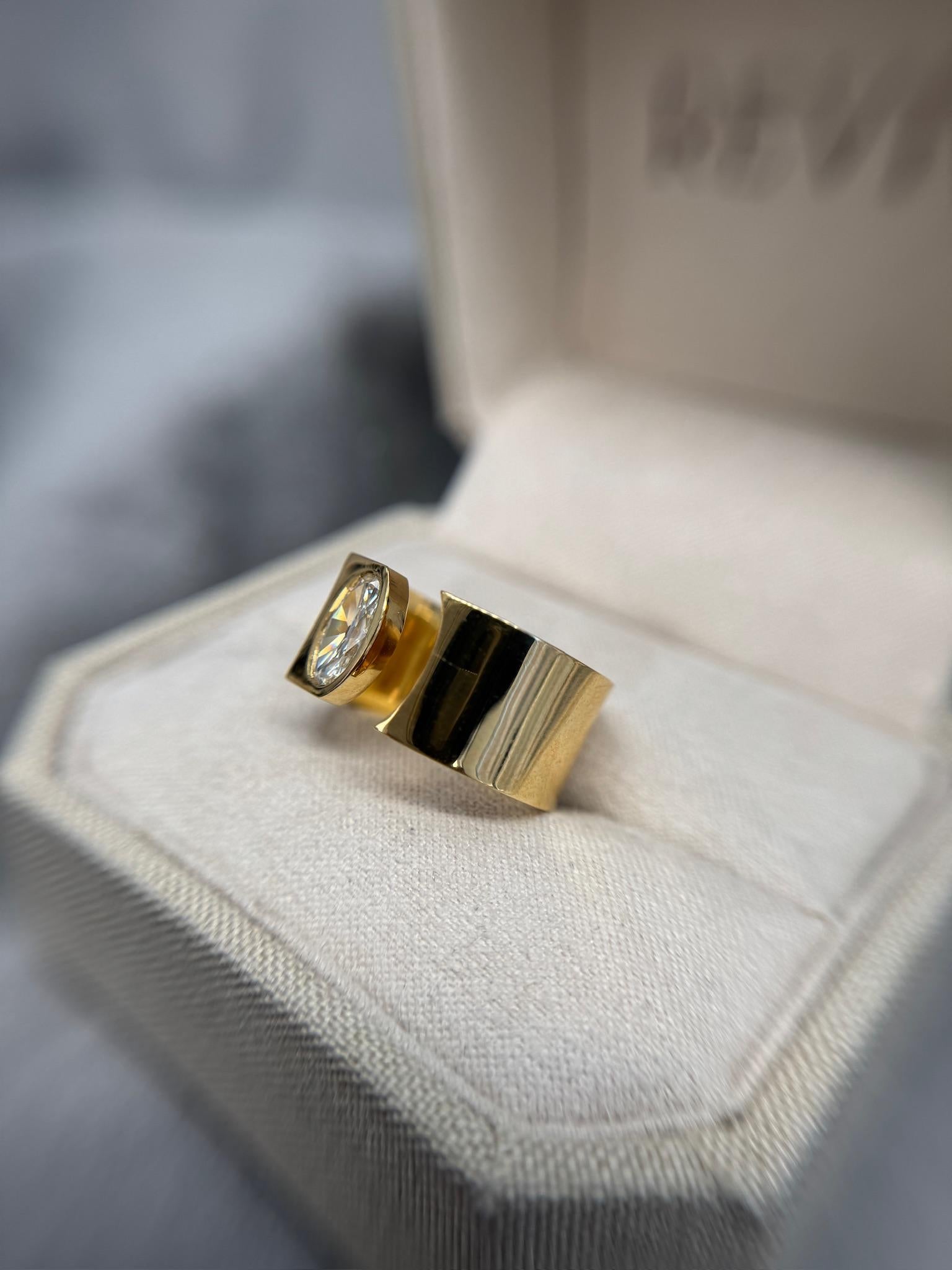 Bold and contemporary, this modern open cigar band features a stunning 0.77ct antique oval diamond, set in luxurious 18k gold. Weighing 13.5g, this statement ring blends vintage charm with a sleek, modern silhouette, making it a standout piece for
