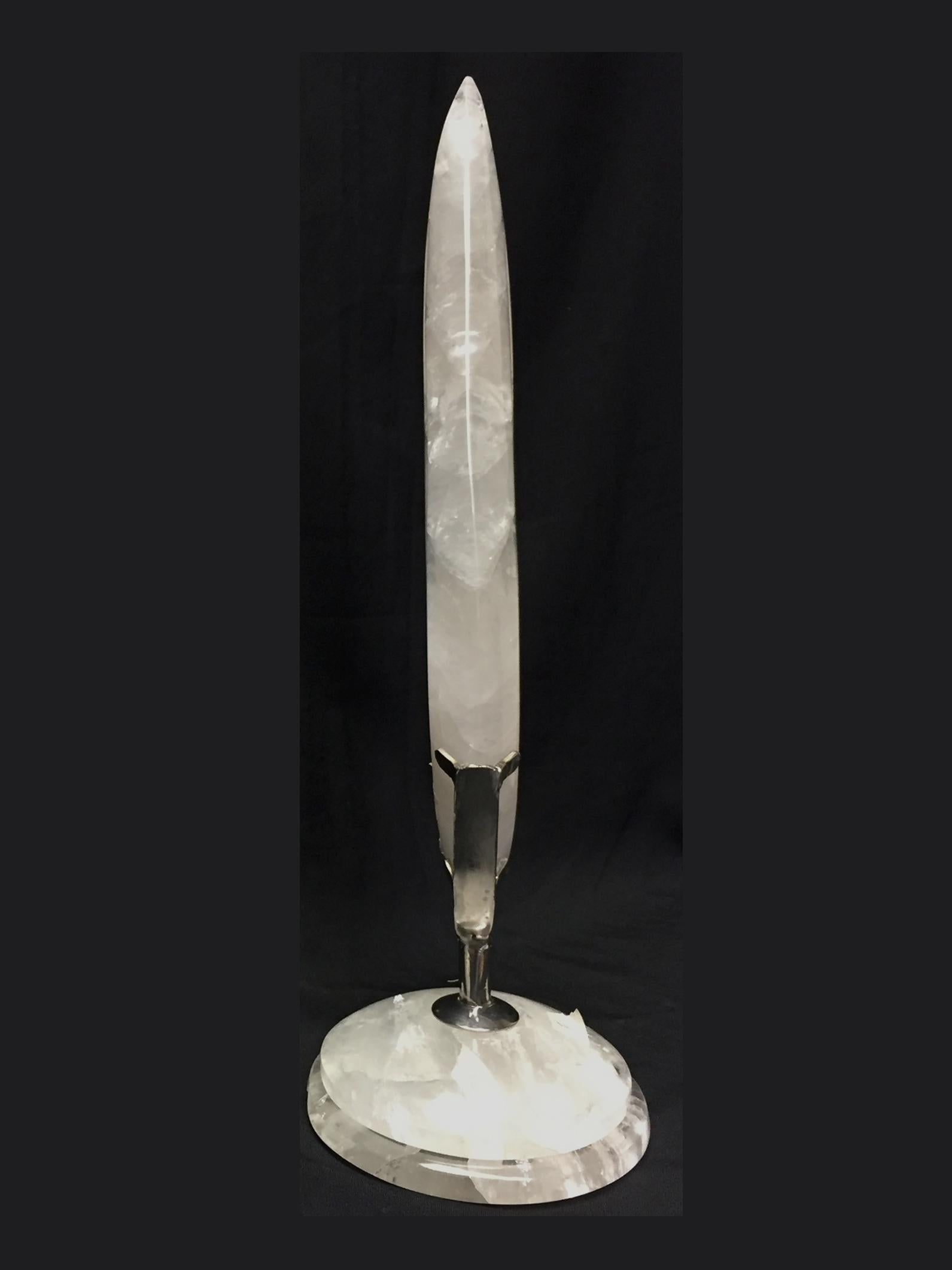 One of kind modern style hand carved and polished rock crystal table ornament on stepped rock crystal base.
The craftsmanship of the carving is shown by how thin the rock crystal was carved.

 