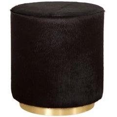 Modern Style Round Chubby Ottoman in Black Cowhide with Polished Brass Toe Kick