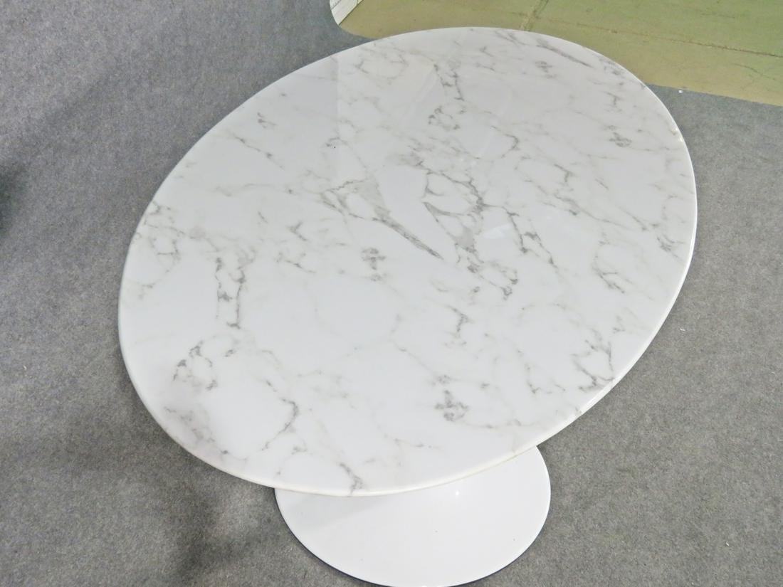 Vintage modern style tulip dining table featuring an oval marble top and metal base.

Please confirm item location with dealer.