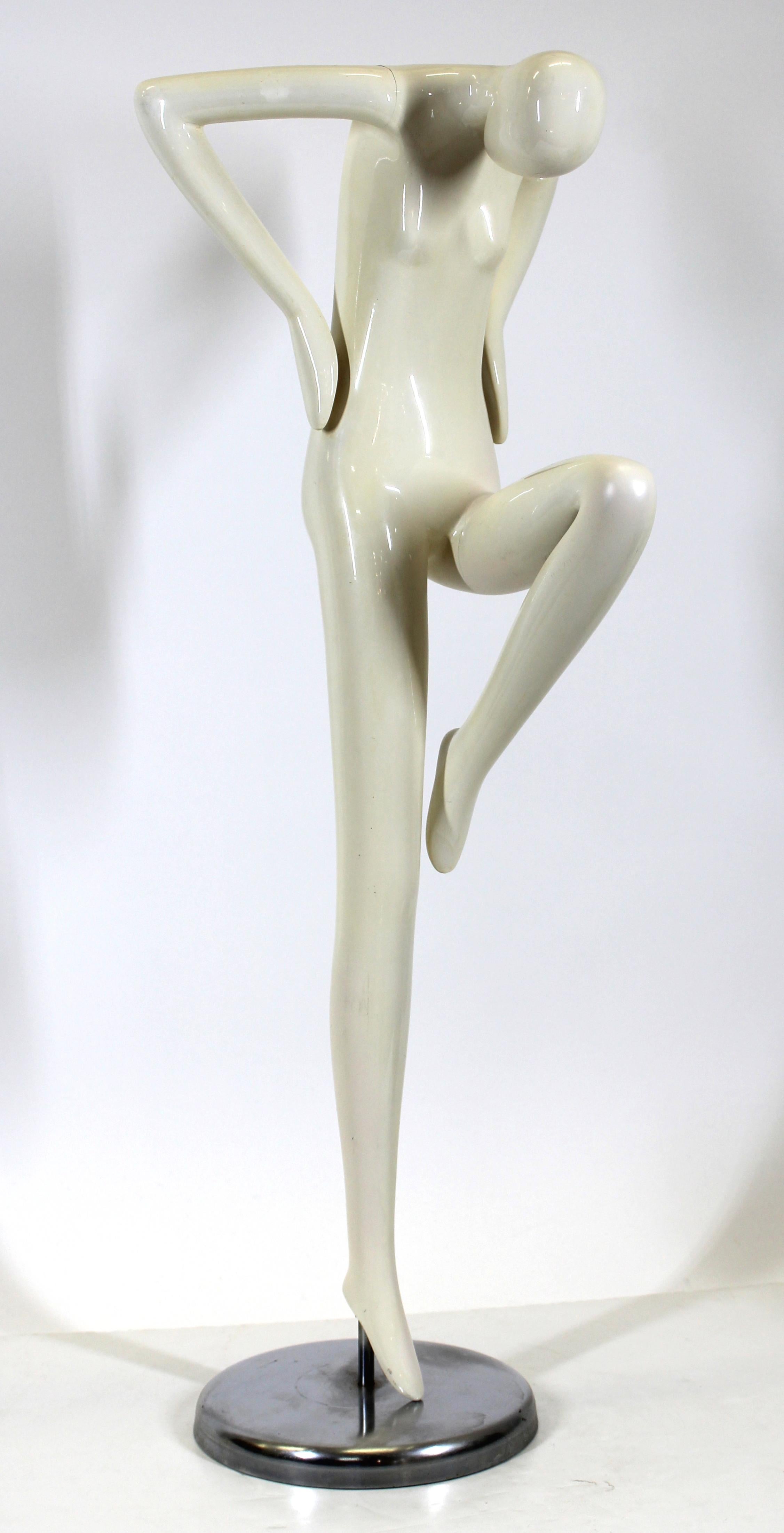 Modern stylized figure of a woman in standing pose, mounted on a metal base, circa late 1970's.