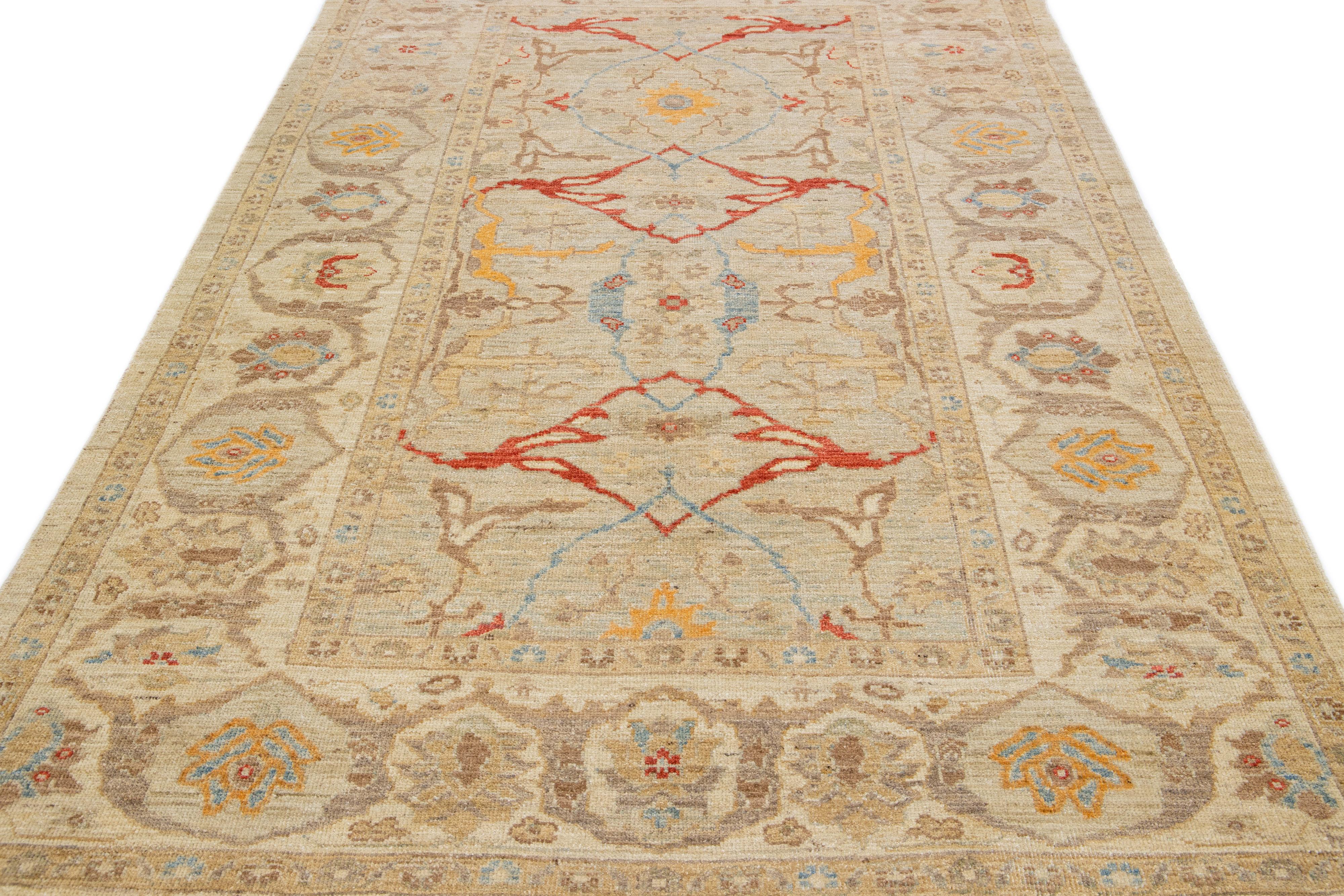 Beautiful modern Sultanabad hand-knotted wool rug with a beige color field. This rug has a designed frame with red, orange, and blue accents in a gorgeous all-over floral design.

This rug measures: 6'1