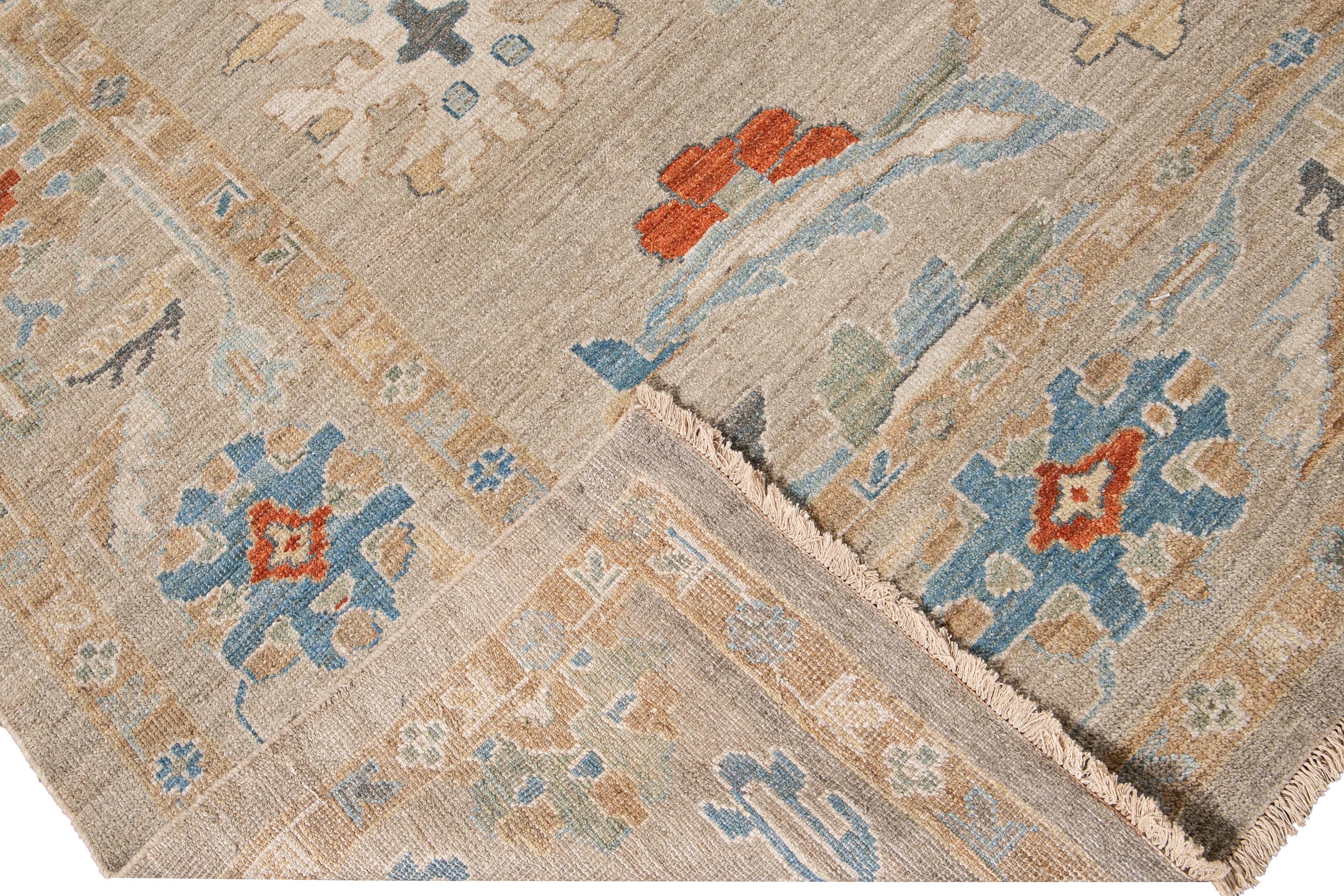 Beautiful modern Sultanabad hand-knotted wool rug with a tan field. This Sultanabad rug has an ivory, yellow, blue, and orange accent in a gorgeous all-over Classic geometric floral design.

This rug measures: 10'4