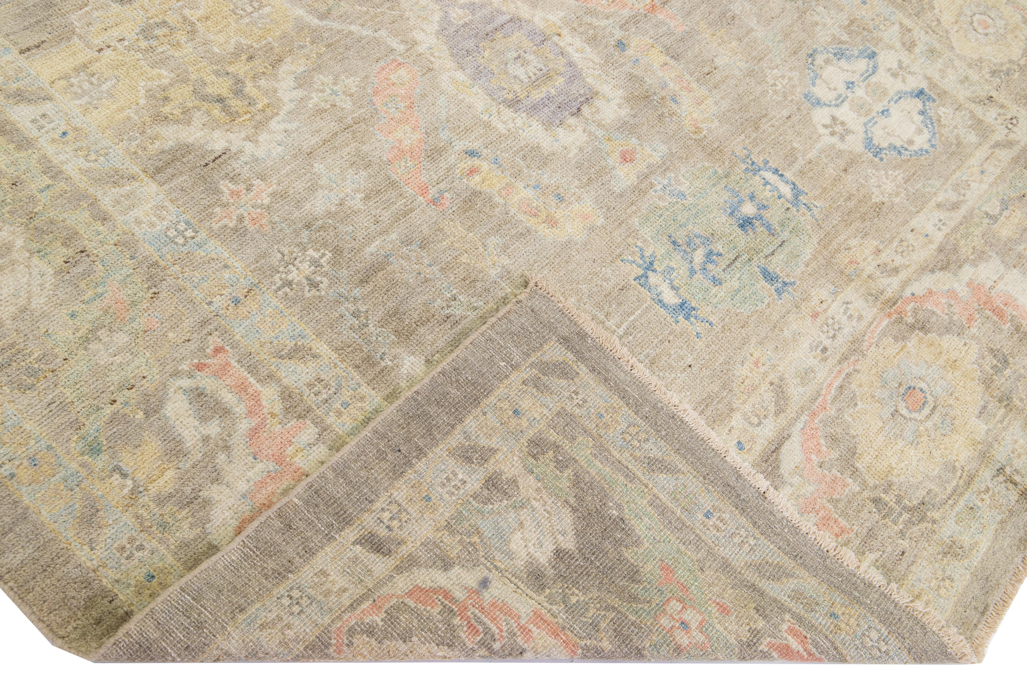 Beautiful modern Sultanabad hand-knotted wool rug with a beige color field. This rug has multicolor accents in a gorgeous all-over floral design.

This rug measures: 6'7