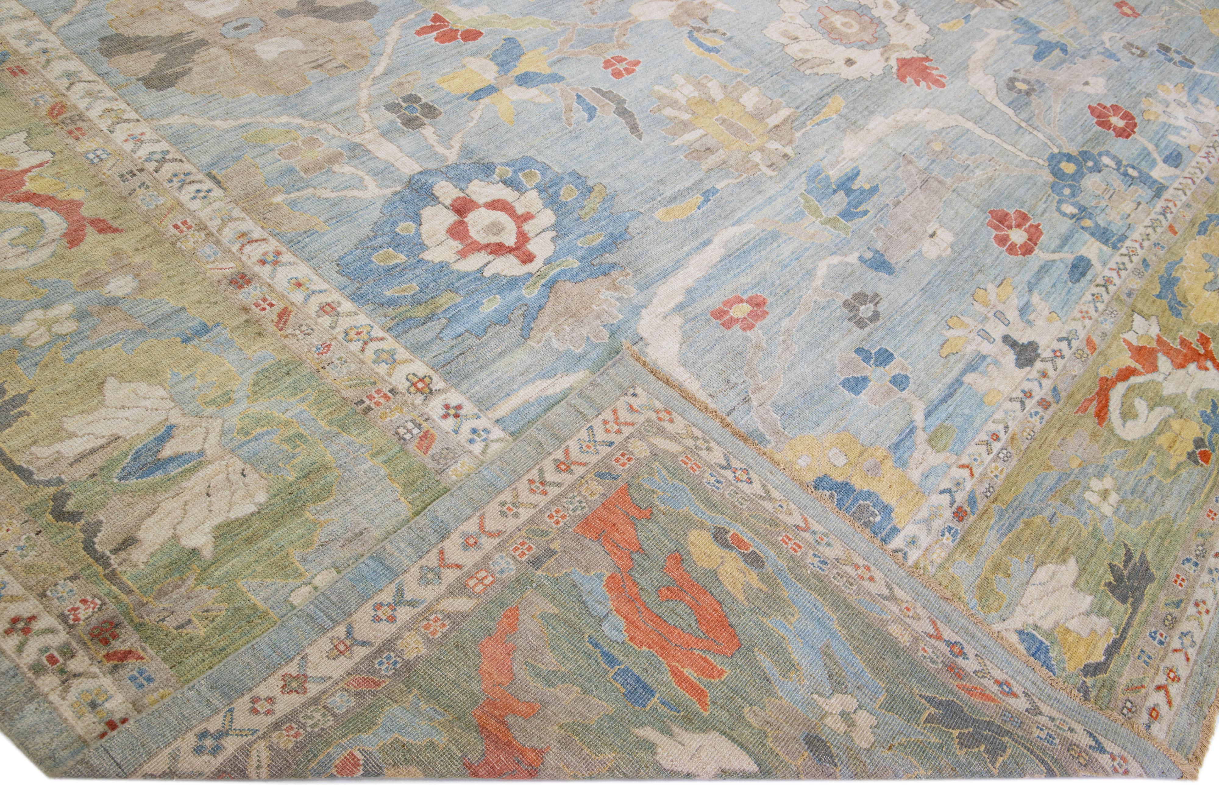 Beautiful modern Sultanabad hand-knotted wool rug with a blue field. This rug has a green frame and multicolor accents in a gorgeous all-over floral design.

This rug measures: 17'6