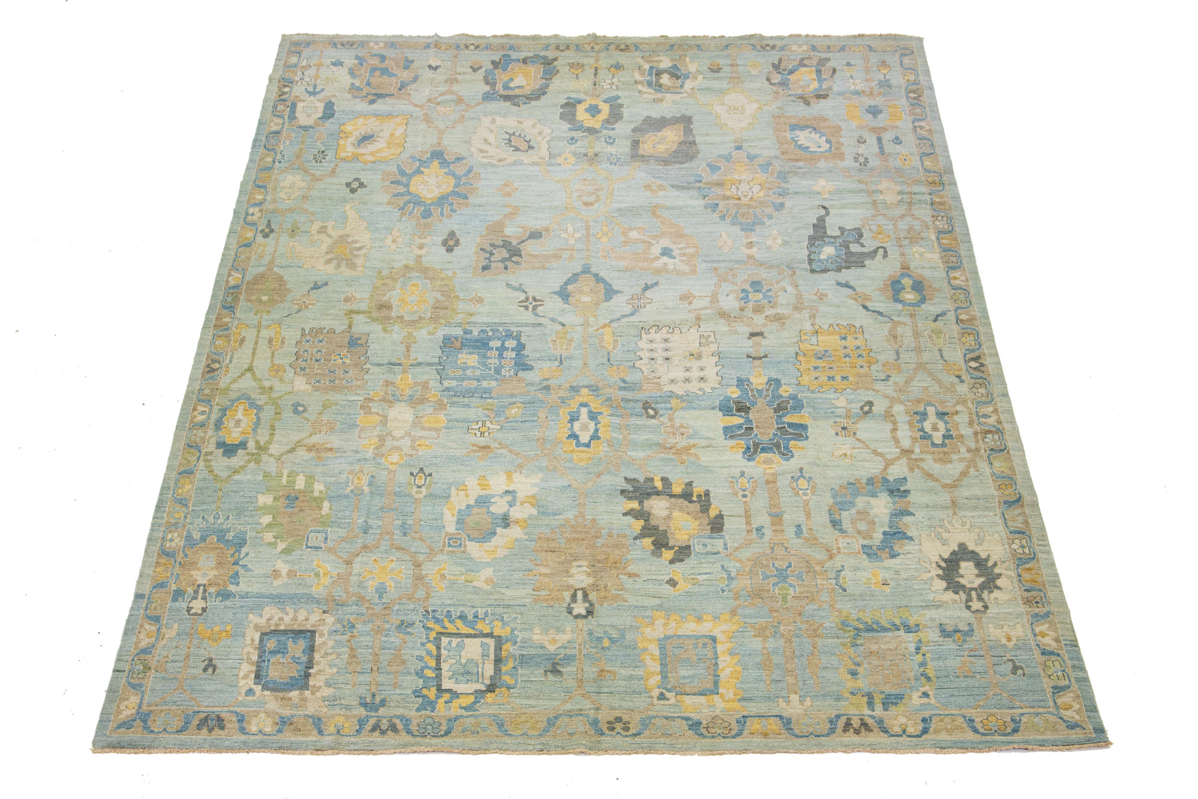 This Sultanabad classic style has been meticulously transformed into a contemporary masterpiece. Crafted with great care, this magnificent wool rug is a blue field. Its frame has a floral motif. To enhance its elegance, it incorporates a design of