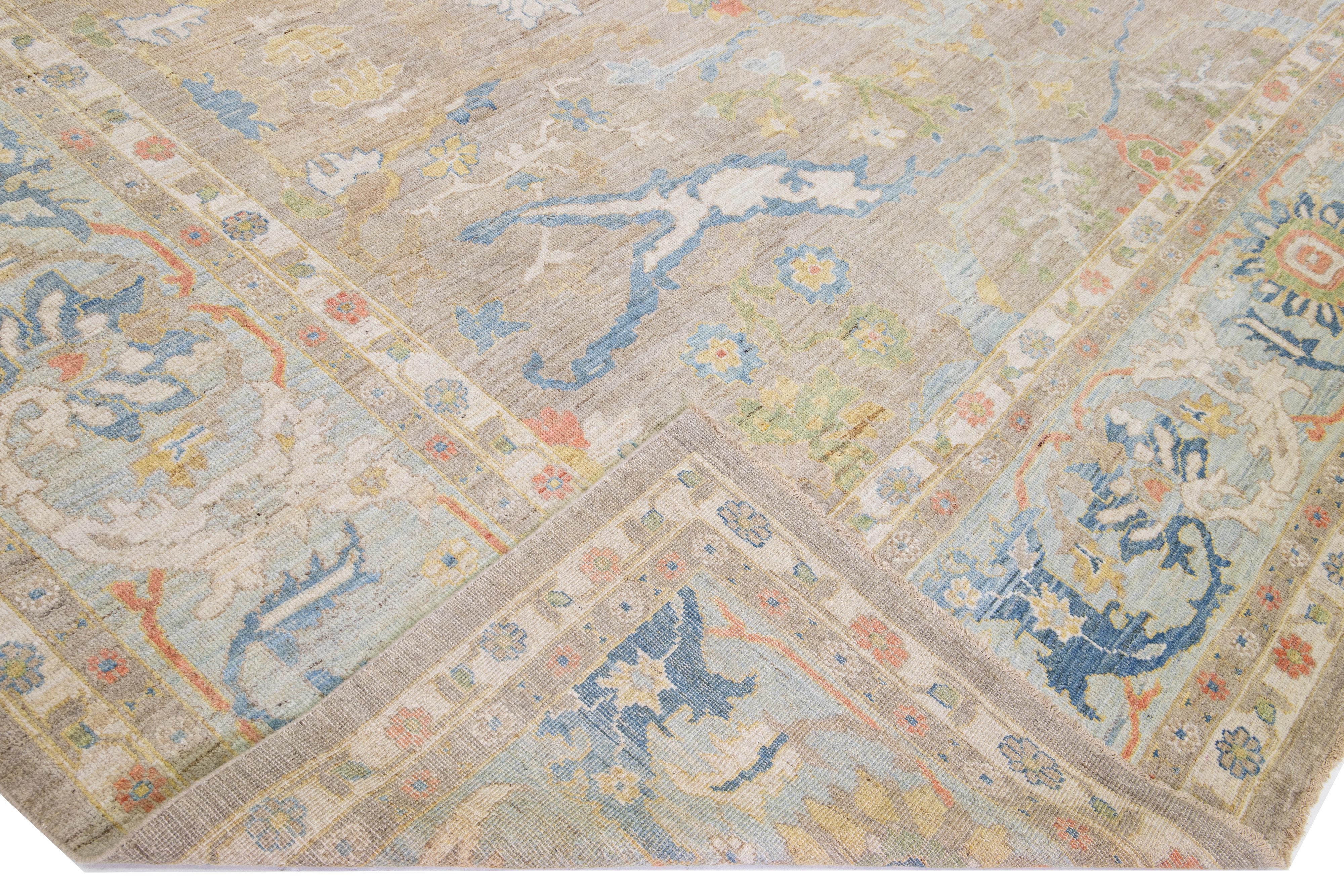 Beautiful modern Sultanabad hand-knotted oversize wool rug with a brown color field. This rug has a blue frame with multicolor accents in a gorgeous all-over floral design.

This rug measures: 14'8