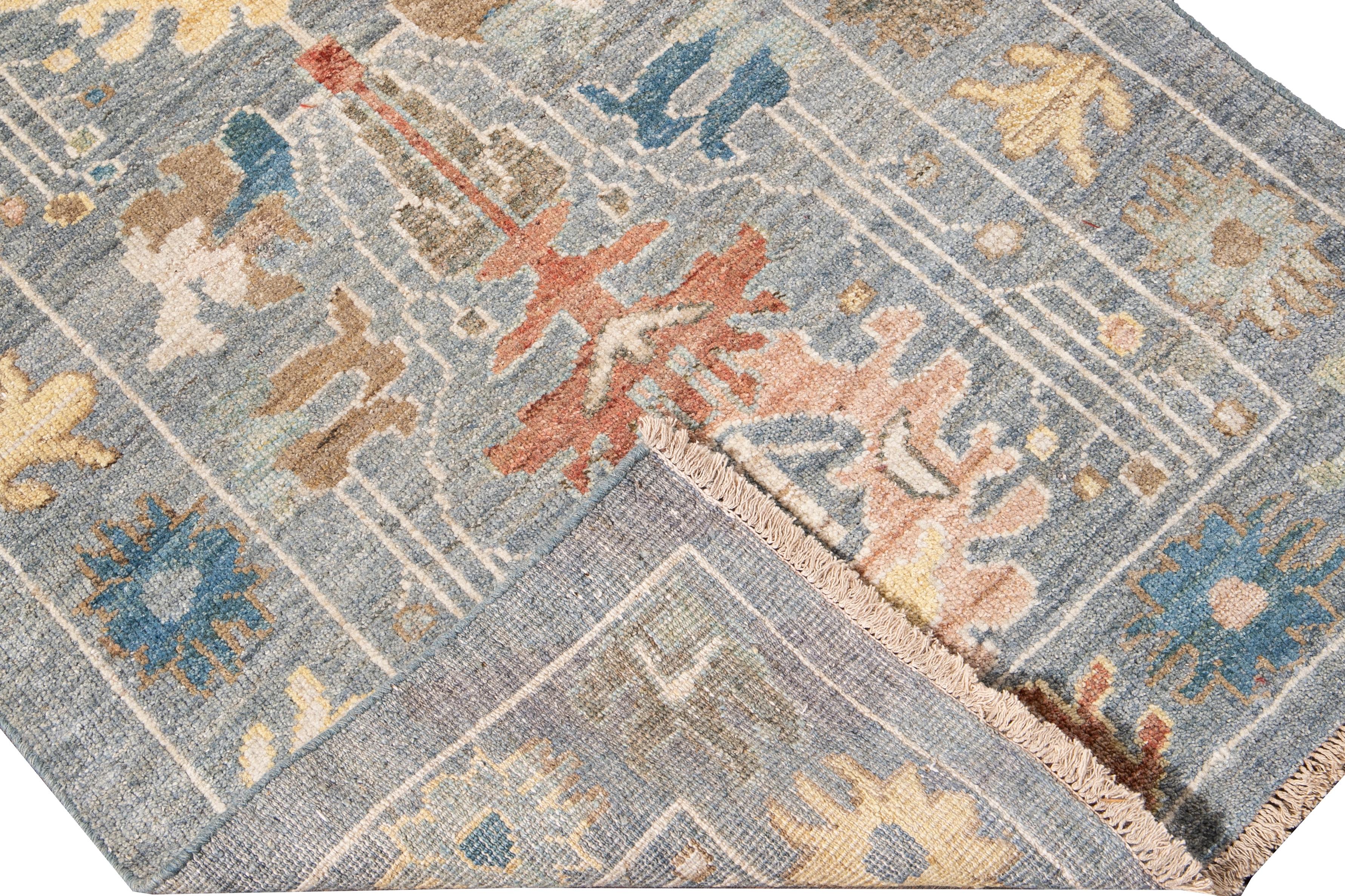 Beautiful modern Sultanabad hand-knotted wool runner with a blue field. This Sultanabad runner has a yellow, green, orange, and brown accent in a gorgeous all-over Classic floral design.

This rug measures: 2'10