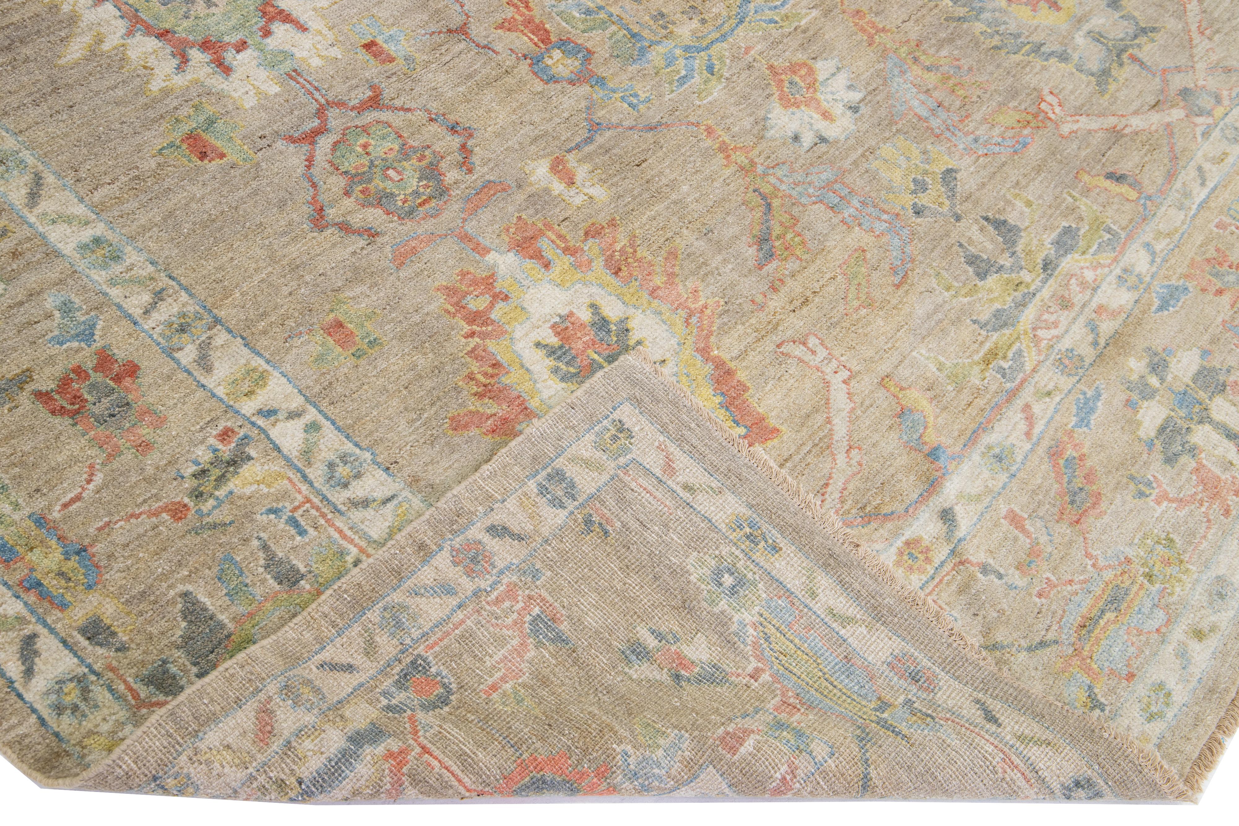 Beautiful modern Sultanabad hand-knotted wool rug with a brown color field. This rug has red, yellow, and green accents in a gorgeous all-over floral design.

This rug measures: 8'5