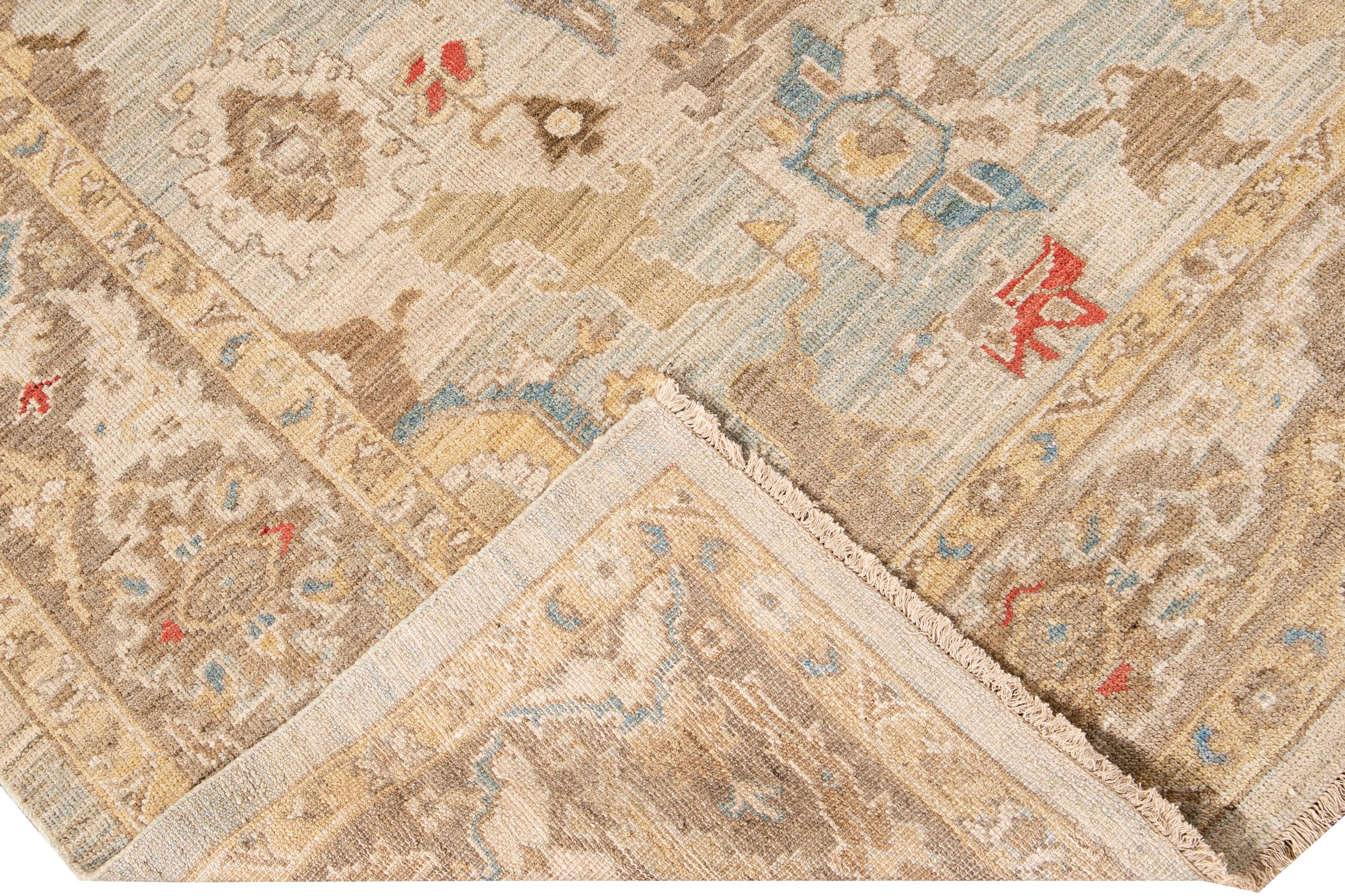 Beautiful modern Sultanabad hand-knotted wool rug with a blue field. This Sultanabad rug has a brown frame beige, yellow, brown, and orange accents in a gorgeous all-over classic geometric floral design.

This rug measures: 8'7