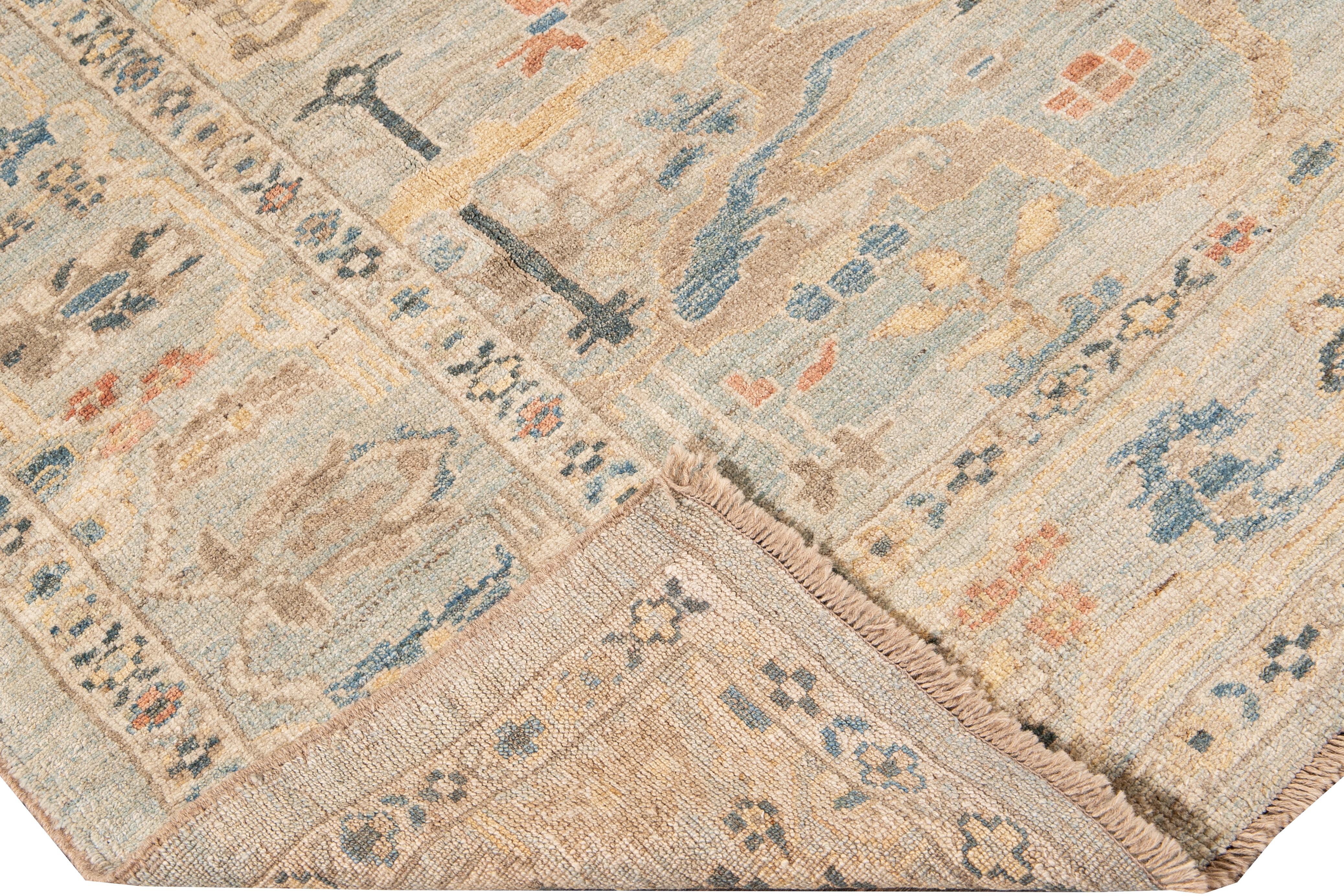 Beautiful modern Sultanabad hand-knotted wool rug with a blue field. This Sultanabad rug has beige, yellow, green, and orange accents in a gorgeous all-over Classic geometric floral design.

This rug measures: 7' x 9'. 

Our rugs are