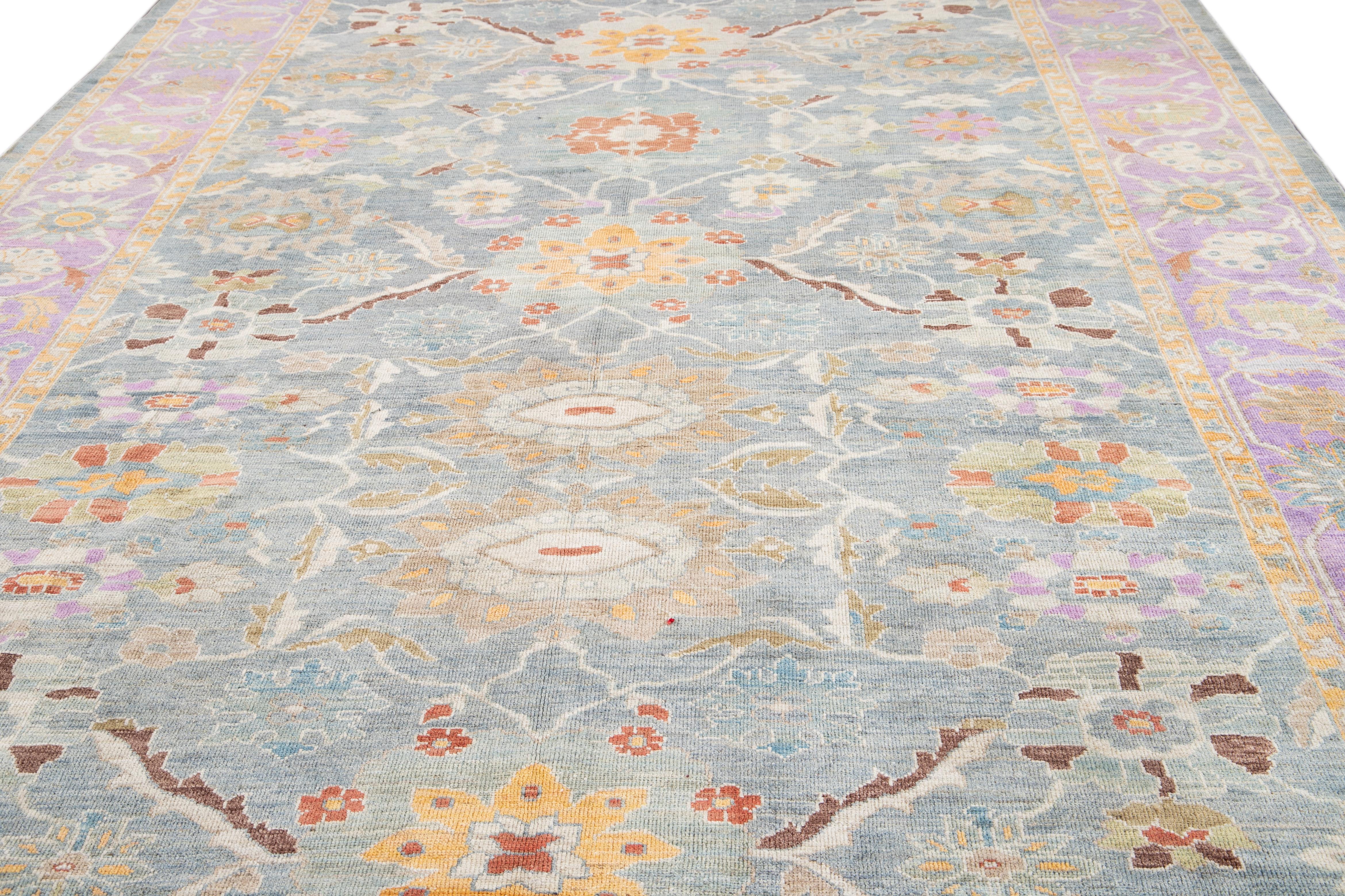 Beautiful contemporary Sultanabad rug hand-knotted wool rug with a blue field. This Persian rug has a purple frame and multi-color accents in a gorgeous floral pattern design.

This rug measures 10' x 16'.