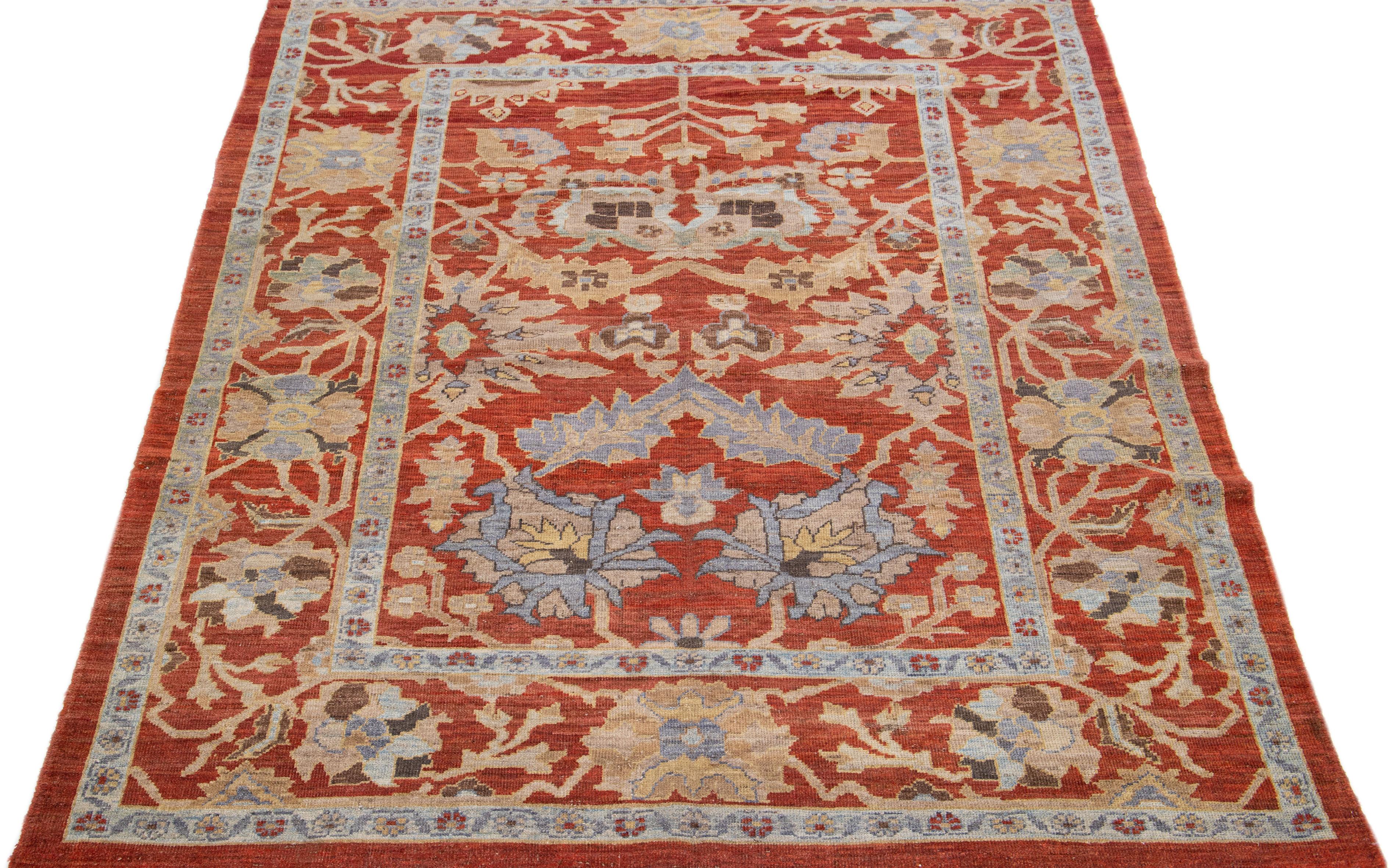 Beautiful modern Sultanabad hand-knotted wool rug with a rust color field. This rug has a designed frame with tan, gray, and brown accents in a gorgeous all-over floral design.

This rug measures: 6'6