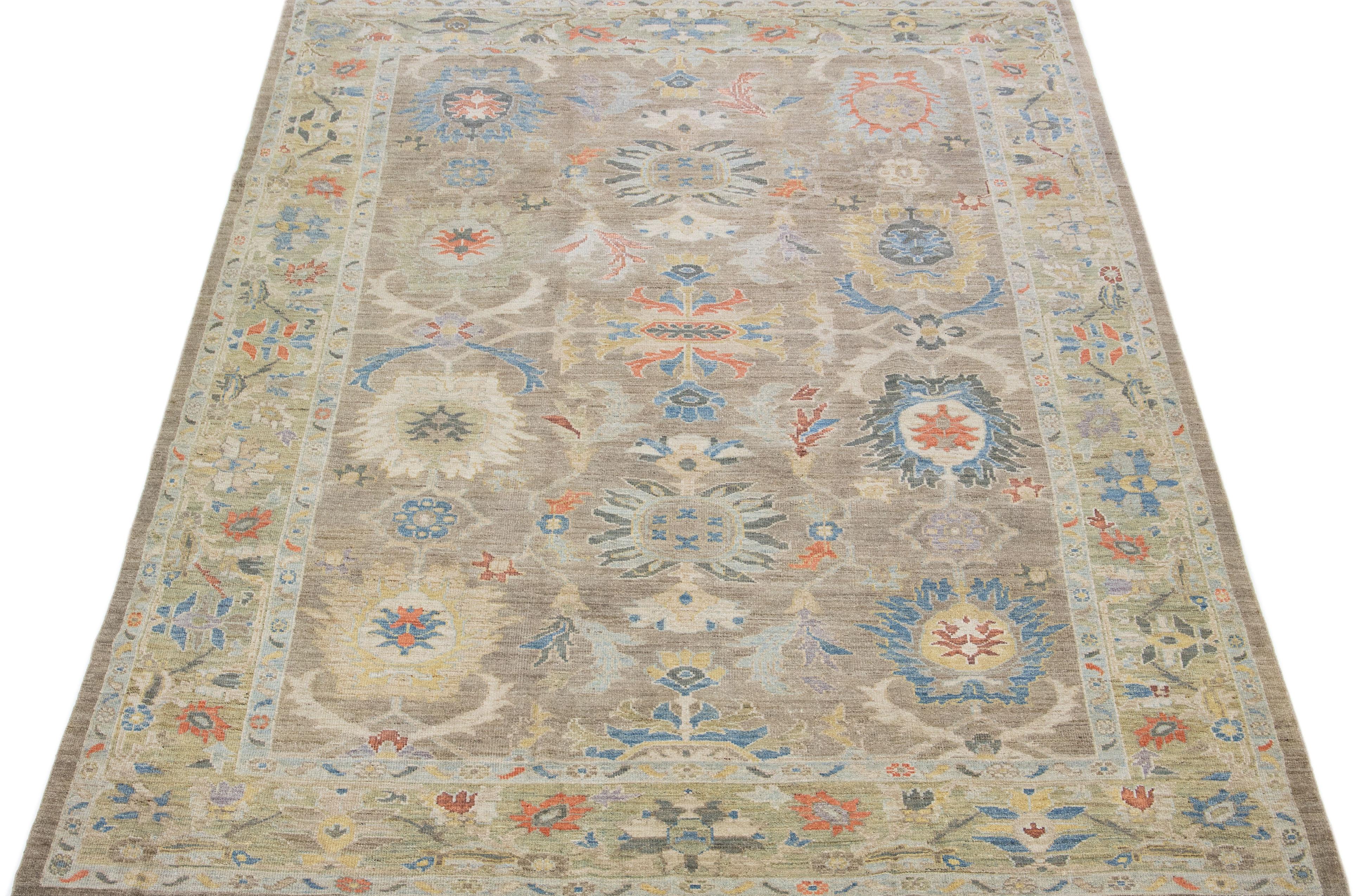 Beautiful modern Sultanabad hand-knotted wool rug with a light brown color field. This rug has a green-designed frame with multicolor accents in a gorgeous all-over floral design.

This rug measures: 8'9
