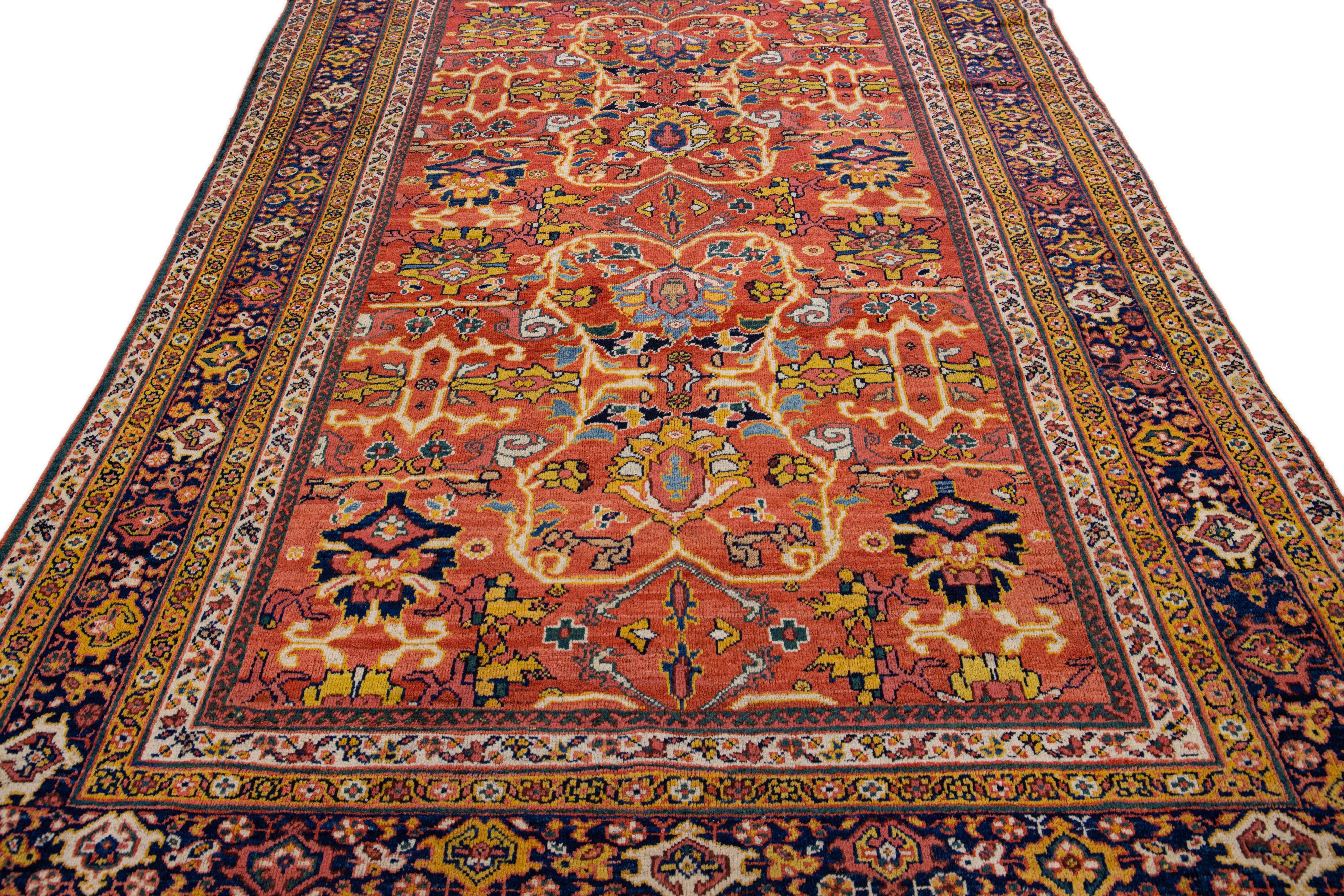 Beautiful modern Sultanabad hand-knotted wool rug with an orange-rust color field. This rug has pink, yellow, and blue accents in a gorgeous all-over floral design.

This rug measures: 6'9