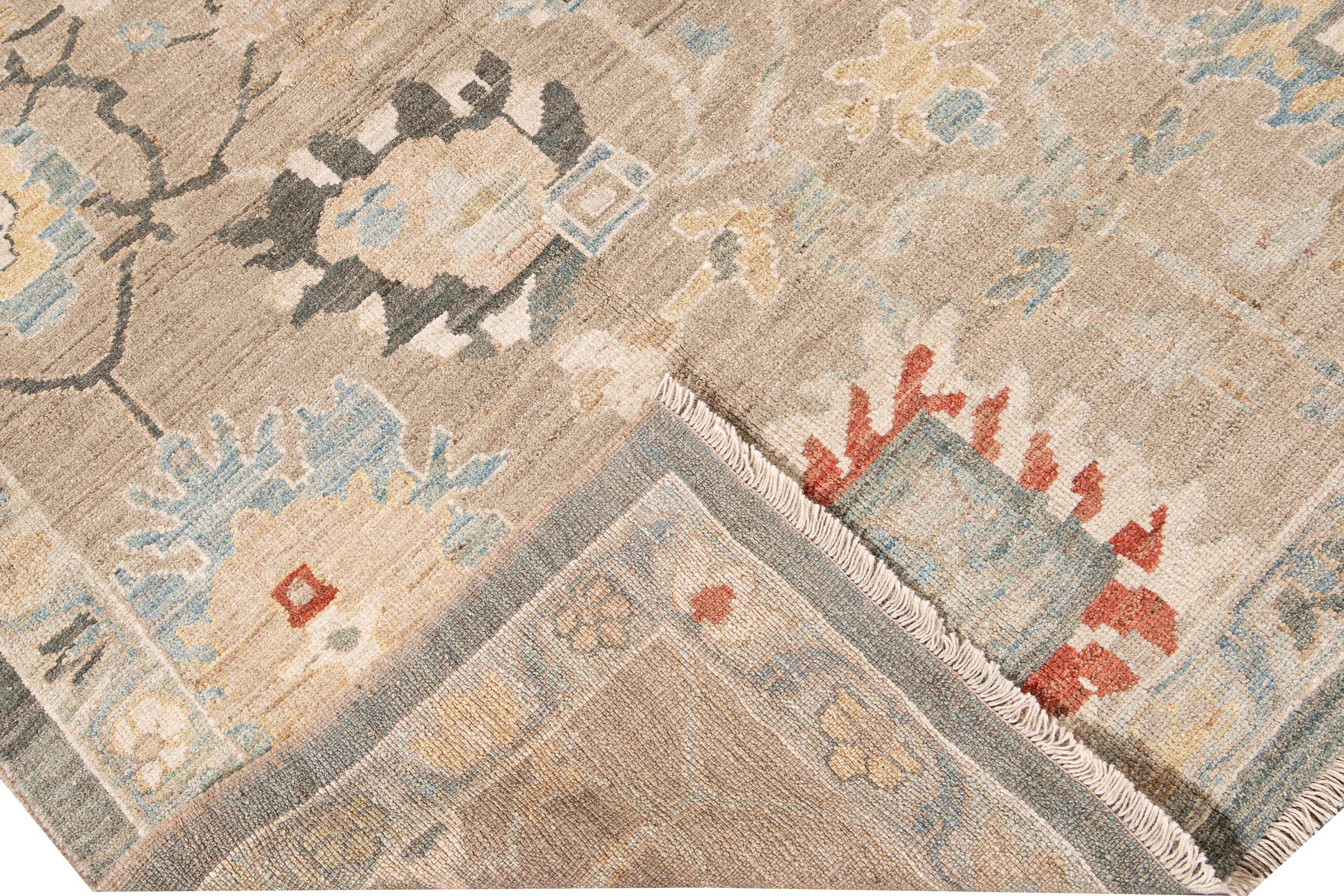 Beautiful modern Sultanabad hand-knotted wool rug with a nude field. This Sultanabad rug has Ivory, yellow, blue, green, and orange accents in a gorgeous all-over geometric floral design.

This rug measures: 9' x 12'1