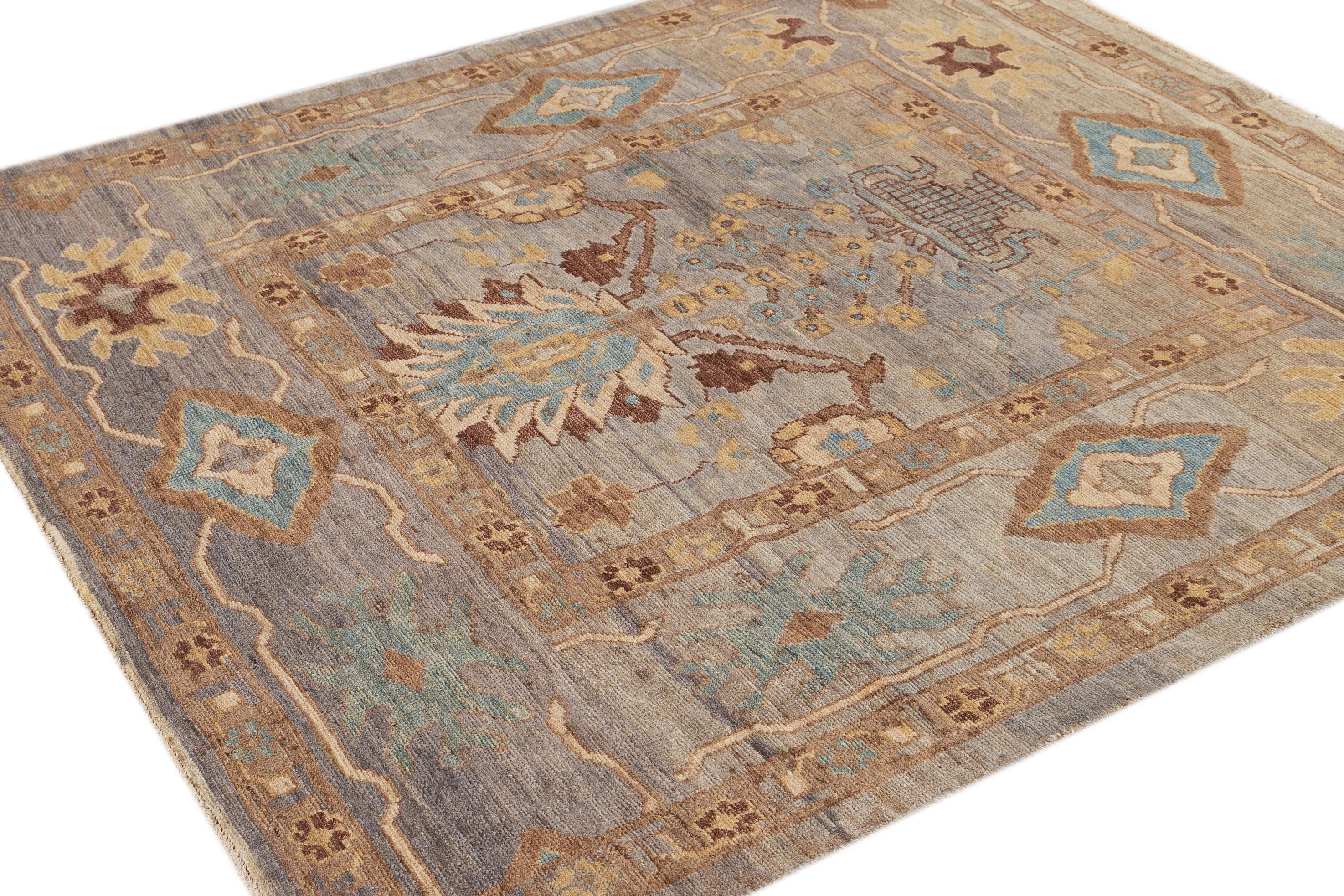 Beautiful modern 21st century Persian Sultanabad rug, hand knotted wool with a light gray field, tan, brown and blue accents in an all-over floral design.

This rug measures: 6' x 6'9